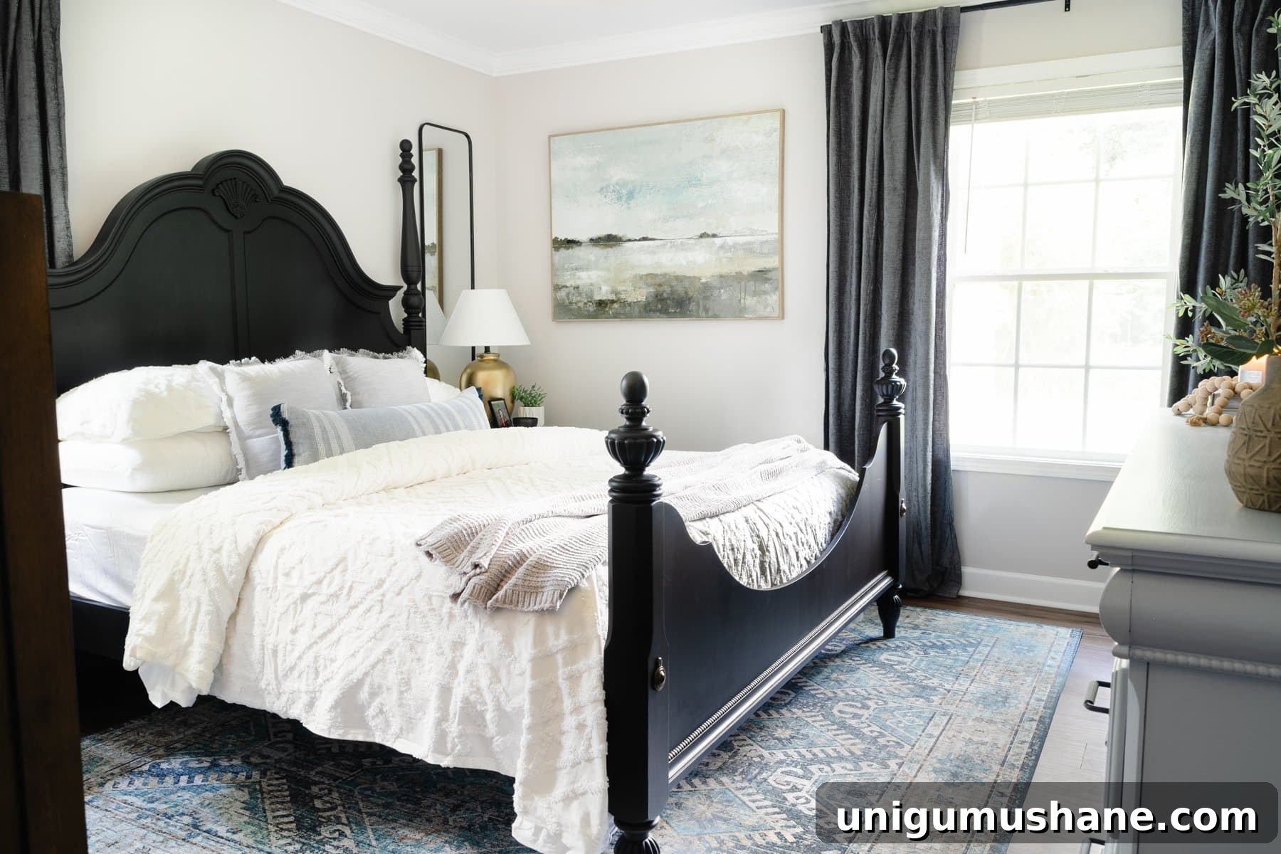 small primary bedroom with black poster bed and gray walls
