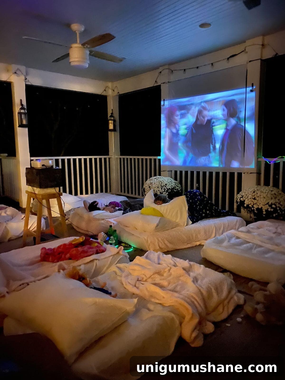 How to Host a Backyard Movie Night on a Budget 15 outside movie night set up on a back porch for a birthday sleepover party