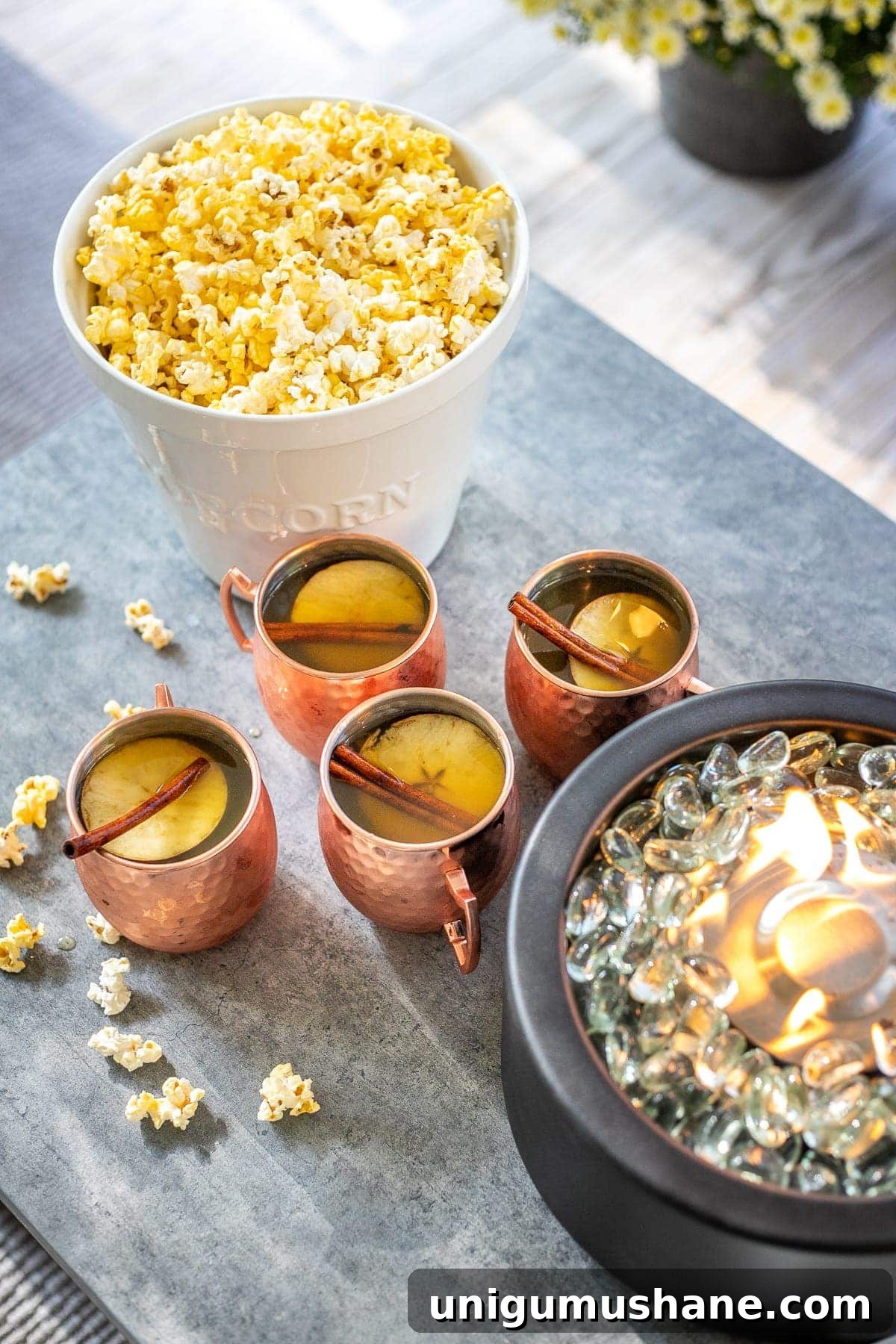 How to Host a Backyard Movie Night on a Budget 18 bucket of popcorn and copper mugs of apple cider