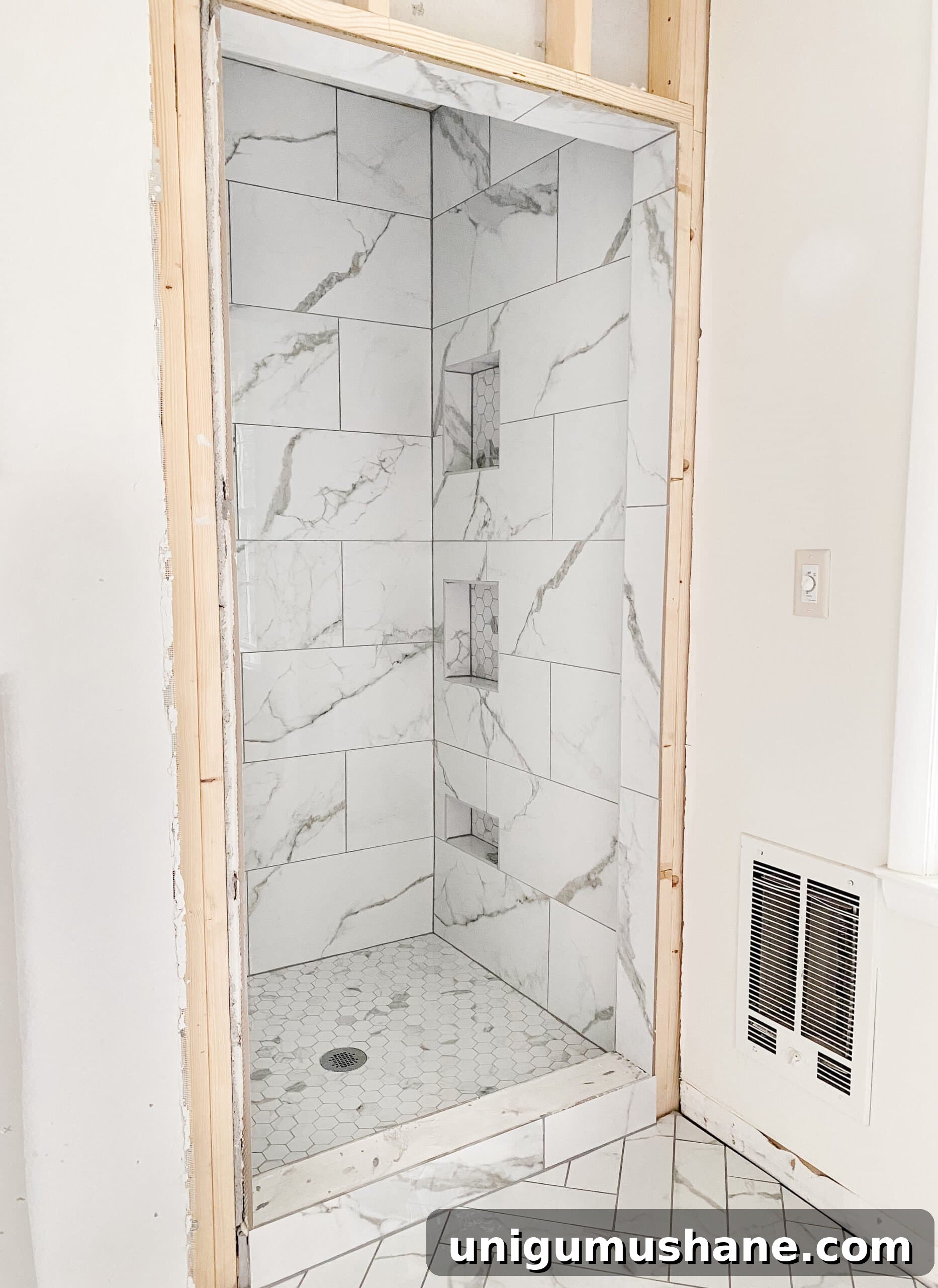 Faux Marble Herringbone Tile and Shower Renovation Update 9 faux marble herringbone tile floor and faux marble tile shower with hexagon with gray grout