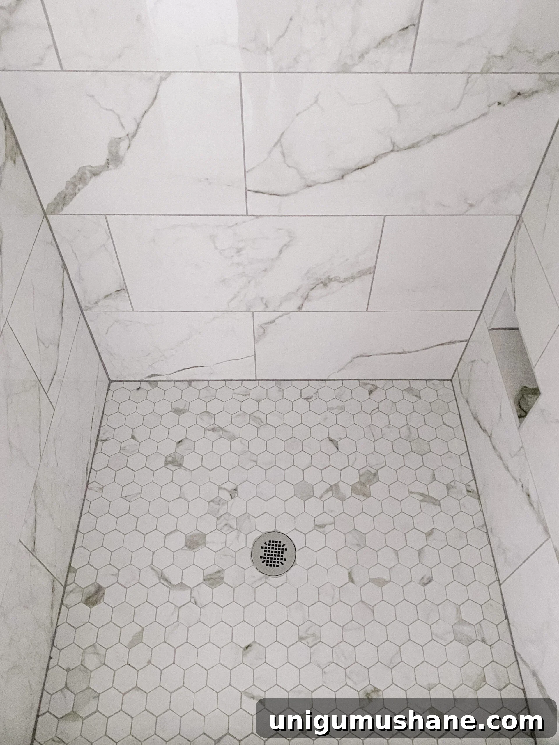 Faux Marble Herringbone Tile and Shower Renovation Update 10 faux marble hexagon tile shower floor with gray grout