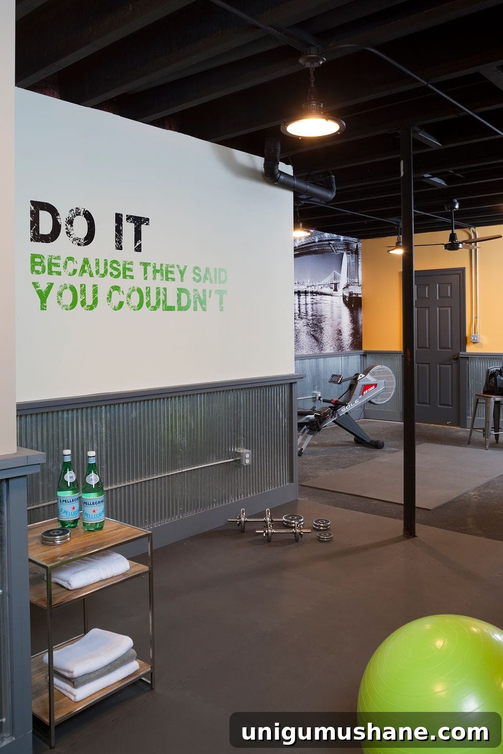 DIY Home Gym Ideas for Basements, Garages, and Sheds 16 home gym with shelf, industrial lighting, and wall quote mural