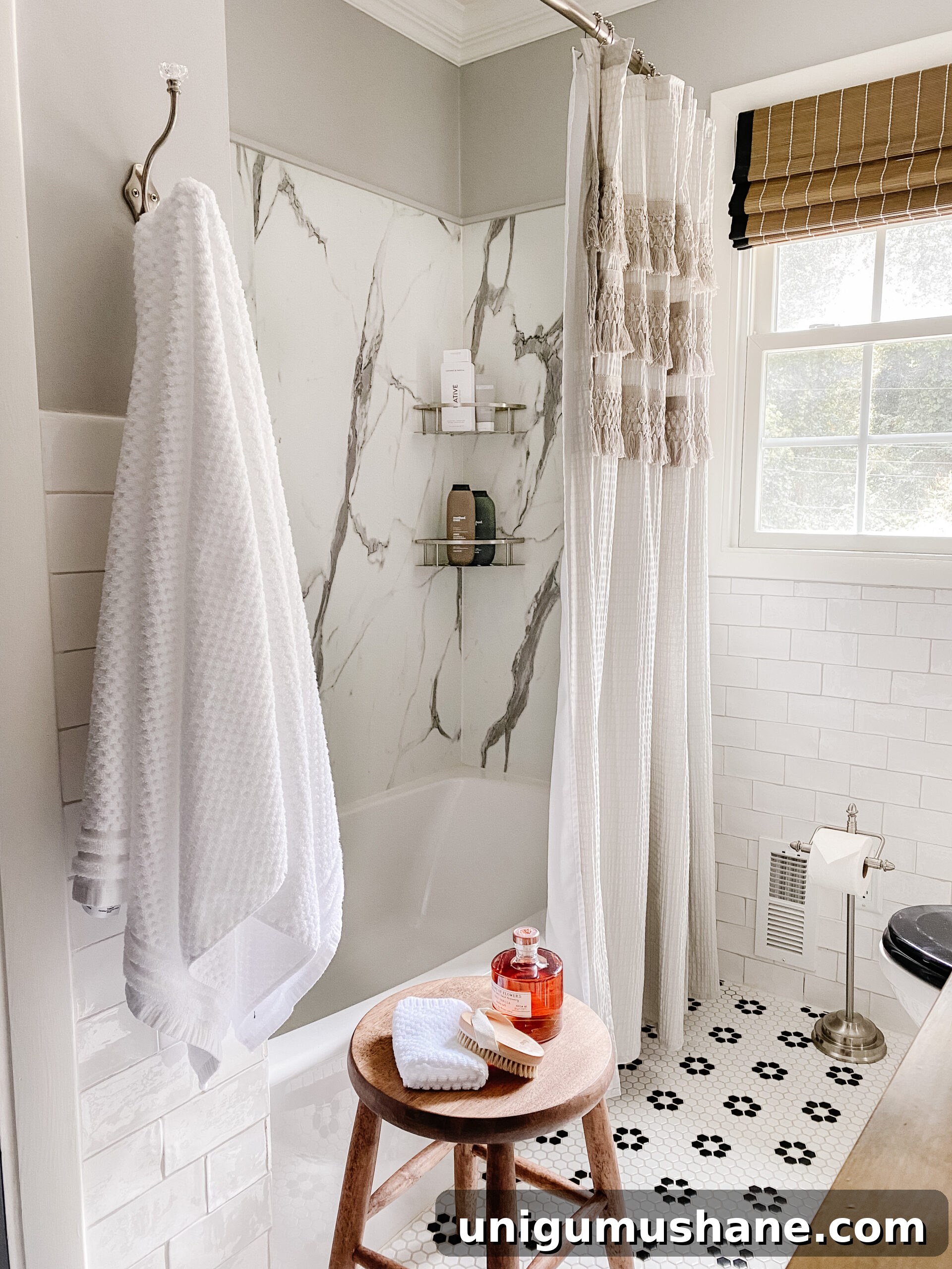 Black and White Bathroom Ideas: Small Swaps for a Classic Look 14 marble shower with black and white retro tile and gray shower curtain