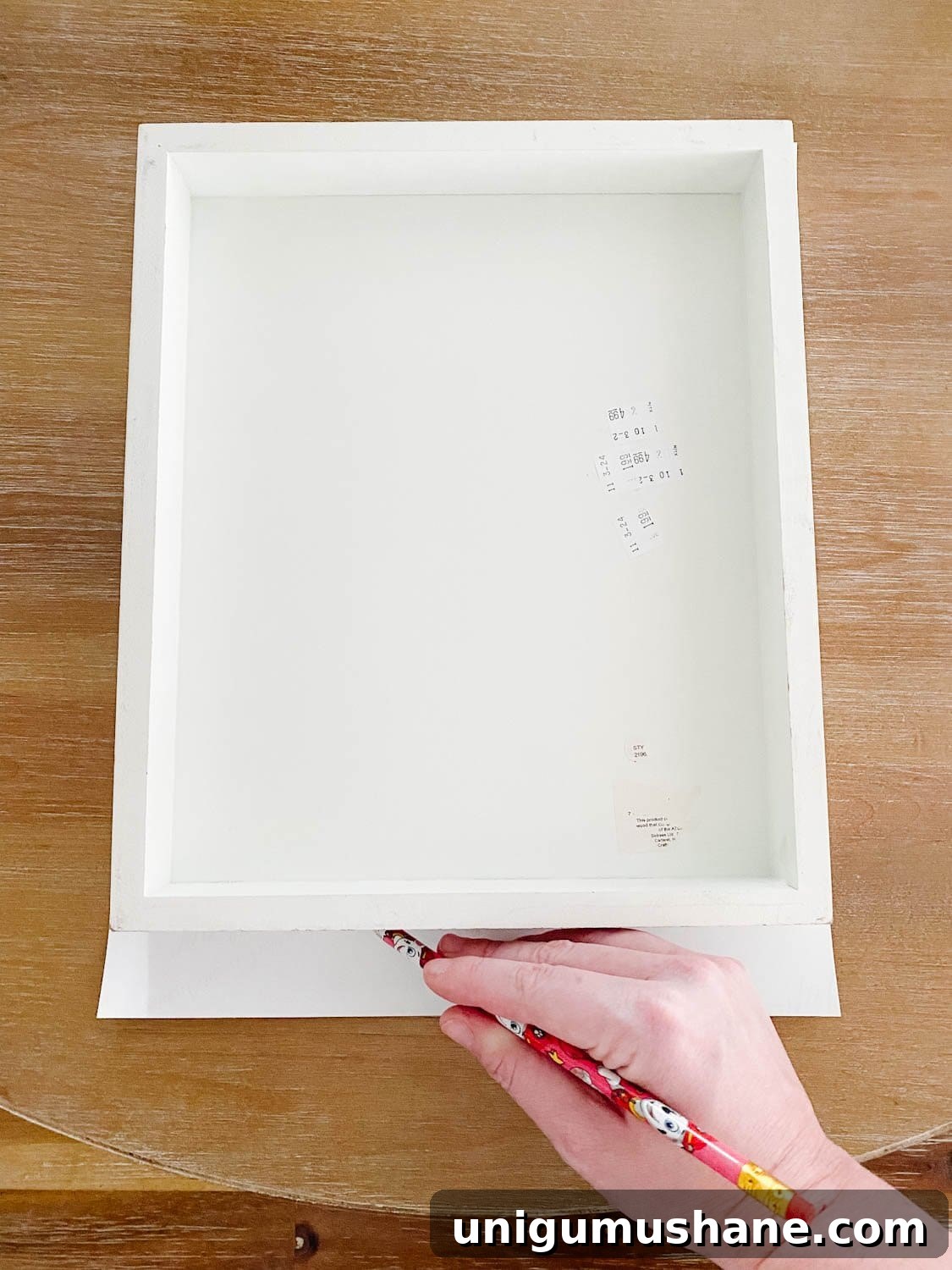 Upcycled Vintage Canvas Art from Old Farmhouse Signs 4 tracing a frame onto a vintage art print to trim