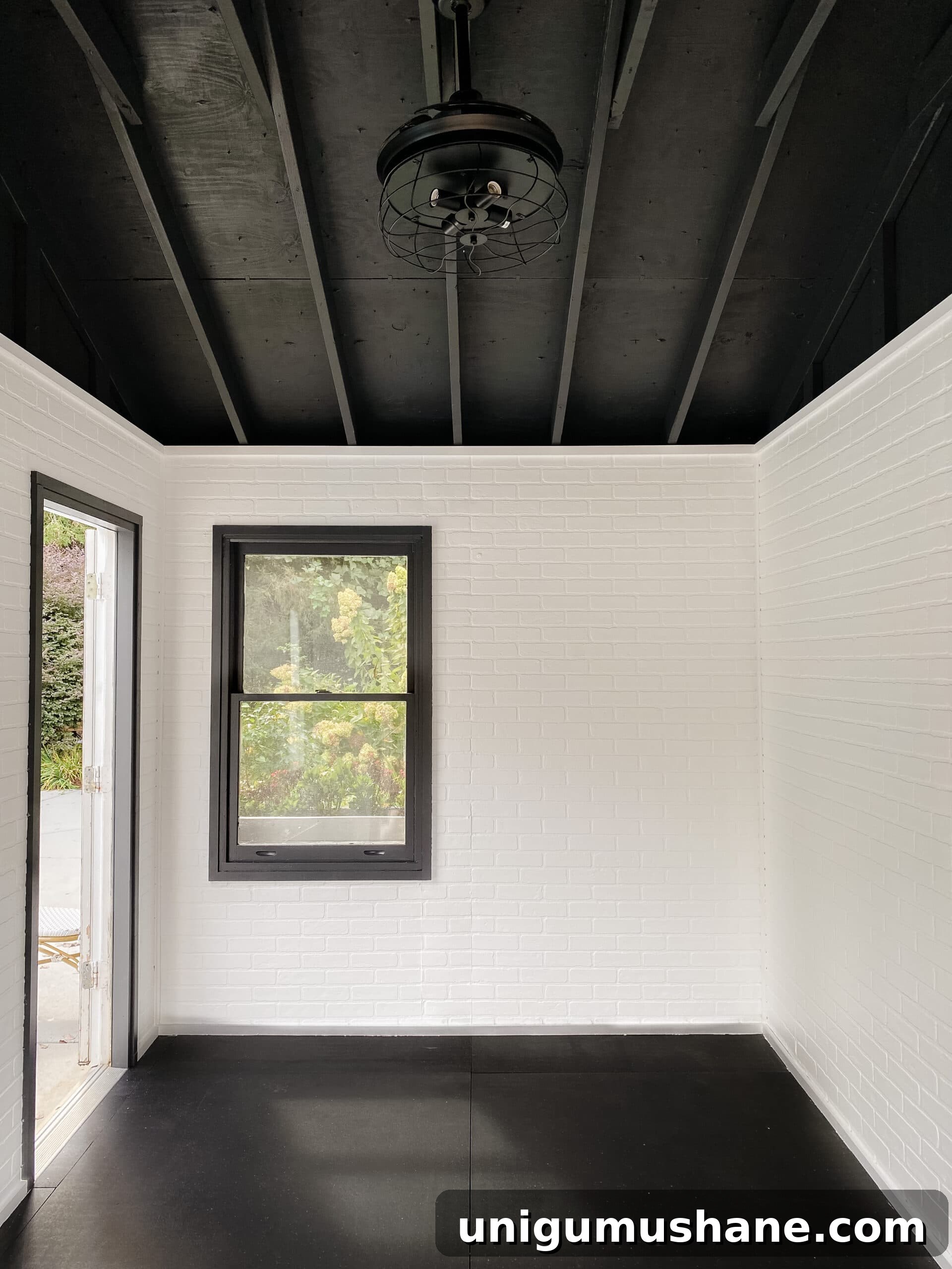 gym shed with white faux brick walls and black ceiling