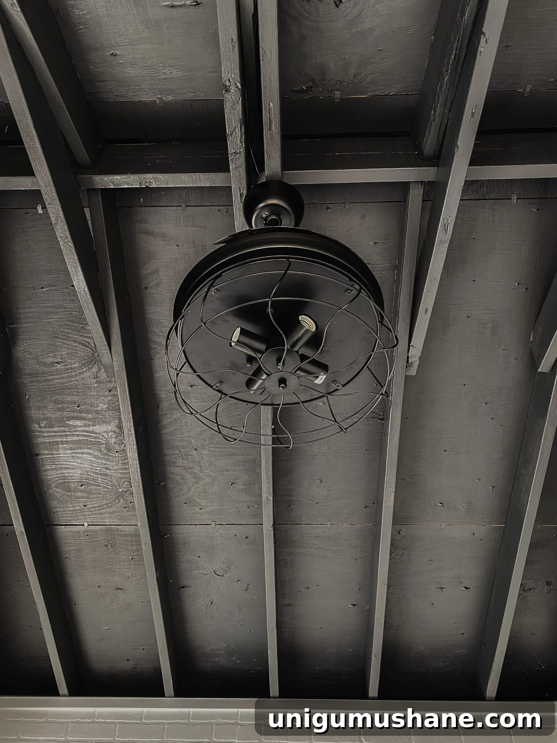 black ceiling with industrial retractable ceiling fan