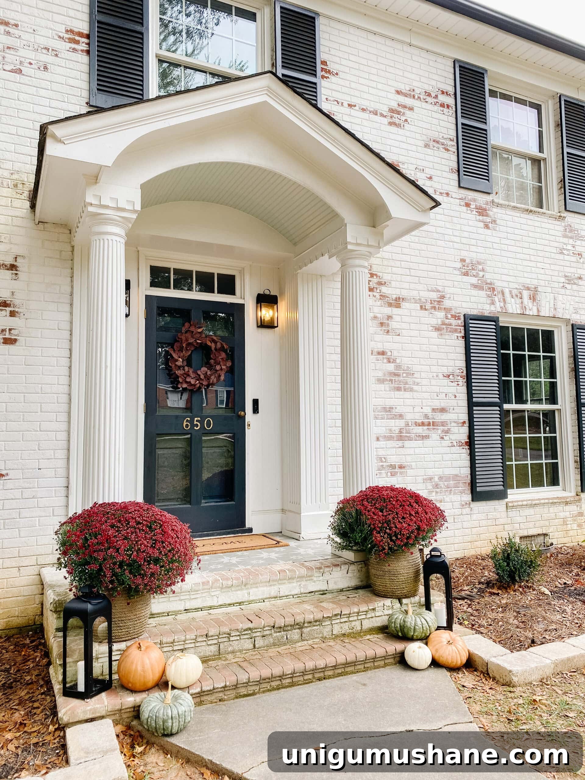 preserved pumpkins on a front porch decorated for fall