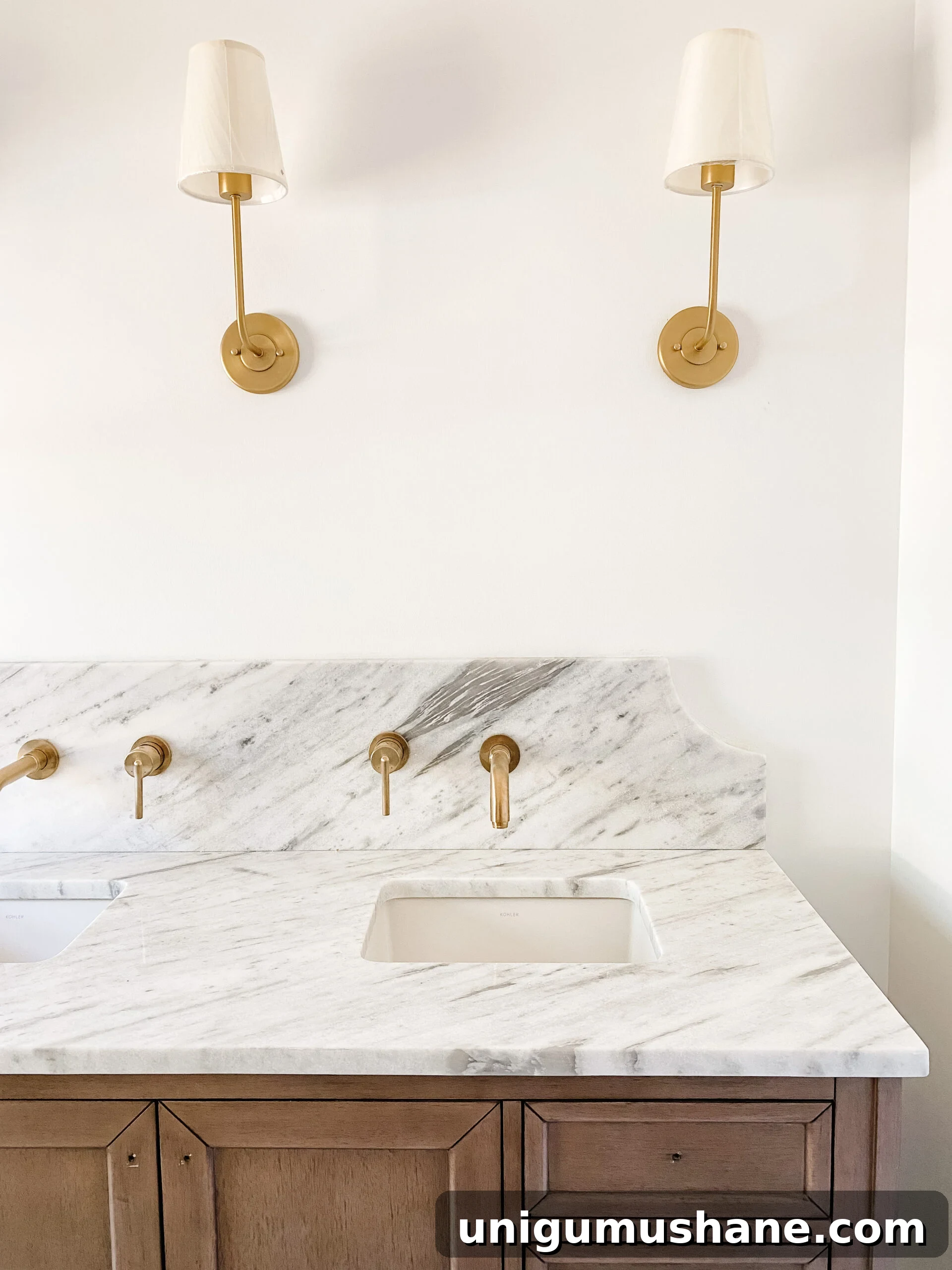En Suite Bathroom Remodel: New Faucets Installed 3 scalloped marble backsplash with gold wall mount faucets in en suite bathroom