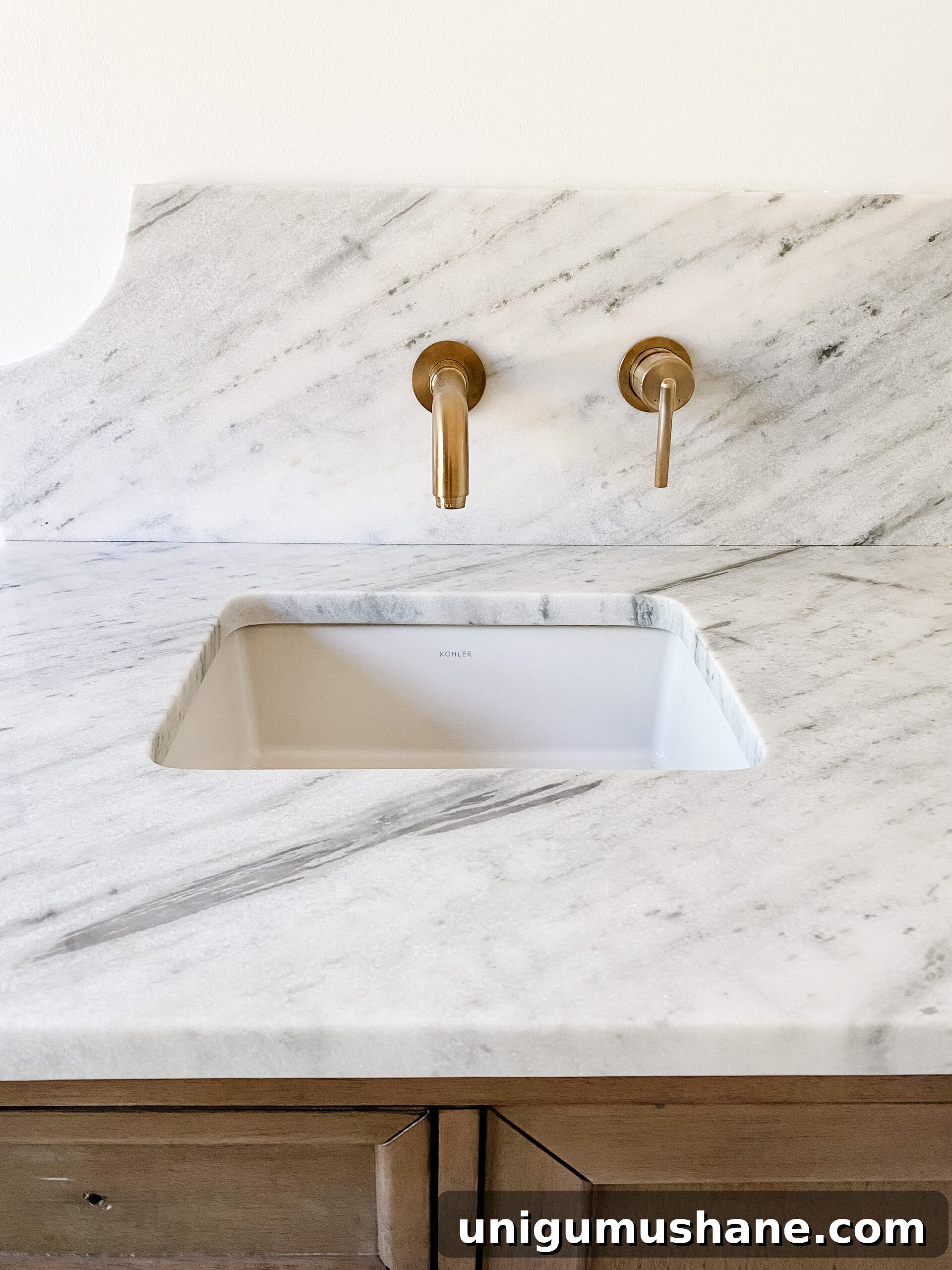 En Suite Bathroom Remodel: New Faucets Installed 4 scalloped marble backsplash with gold wall mount faucets in en suite bathroom