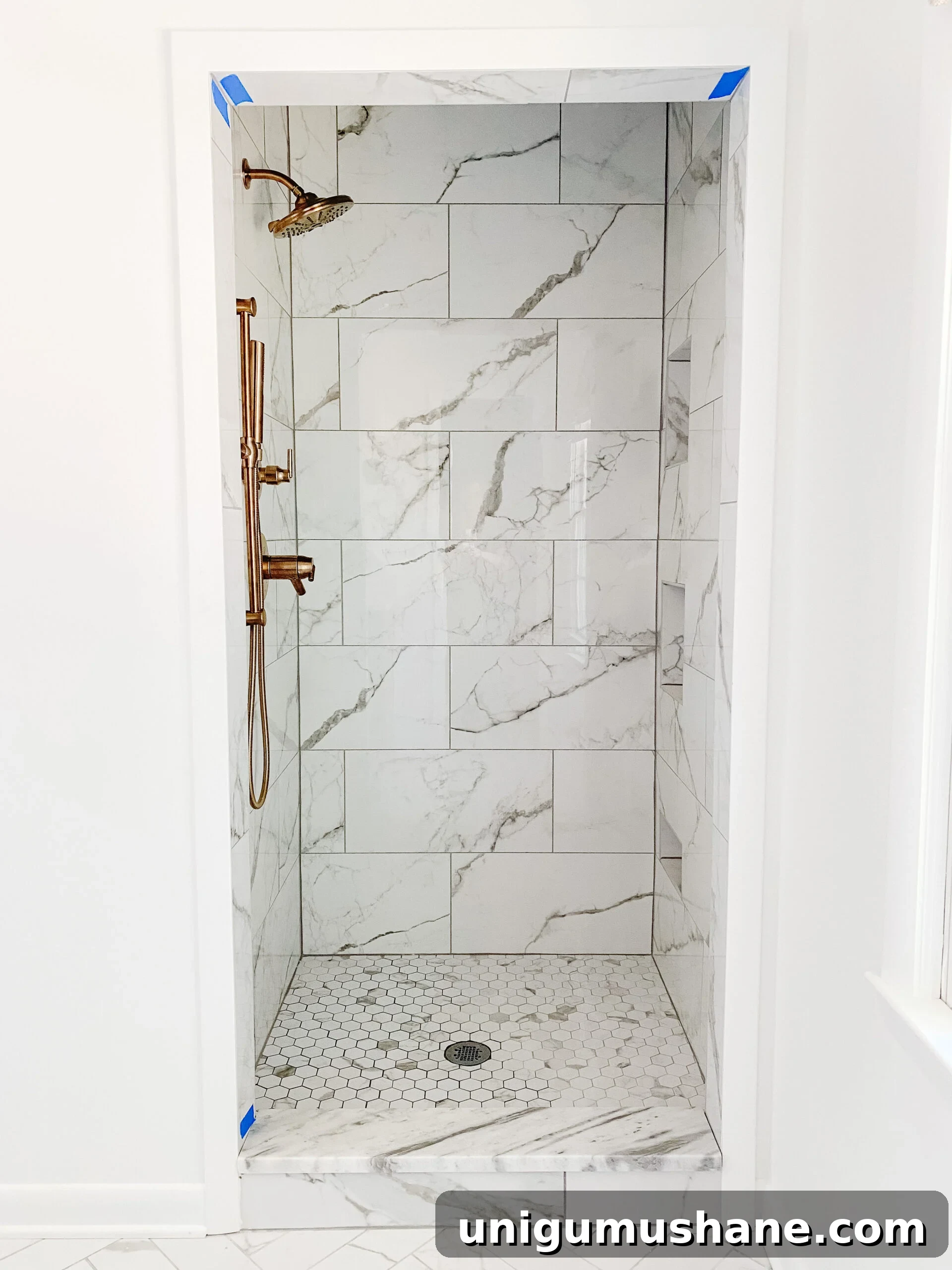 En Suite Bathroom Remodel: New Faucets Installed 8 faux marble porcelain tile shower with gold shower faucets