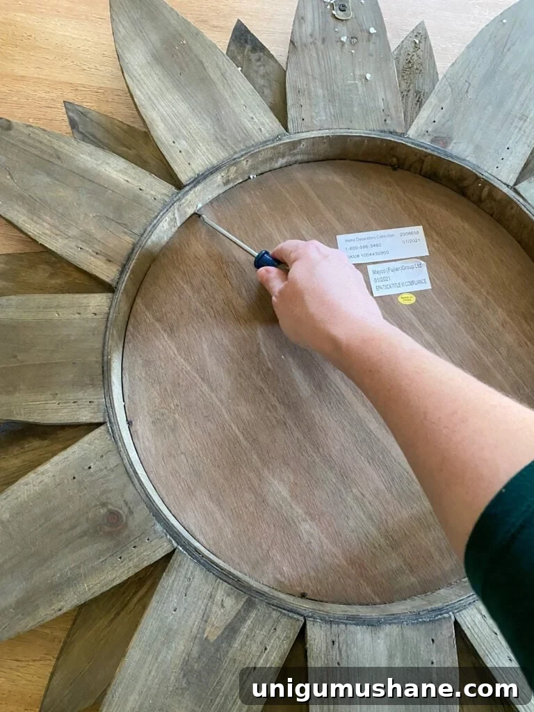 How to Upcycle a Sunburst Mirror into a Stunning Light Fixture 4 removing mirror from sunburst
