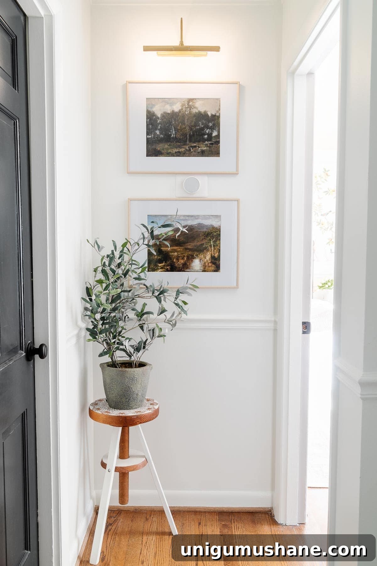 small hallway ideas : add art with secondary lighting to disguise a thermostat