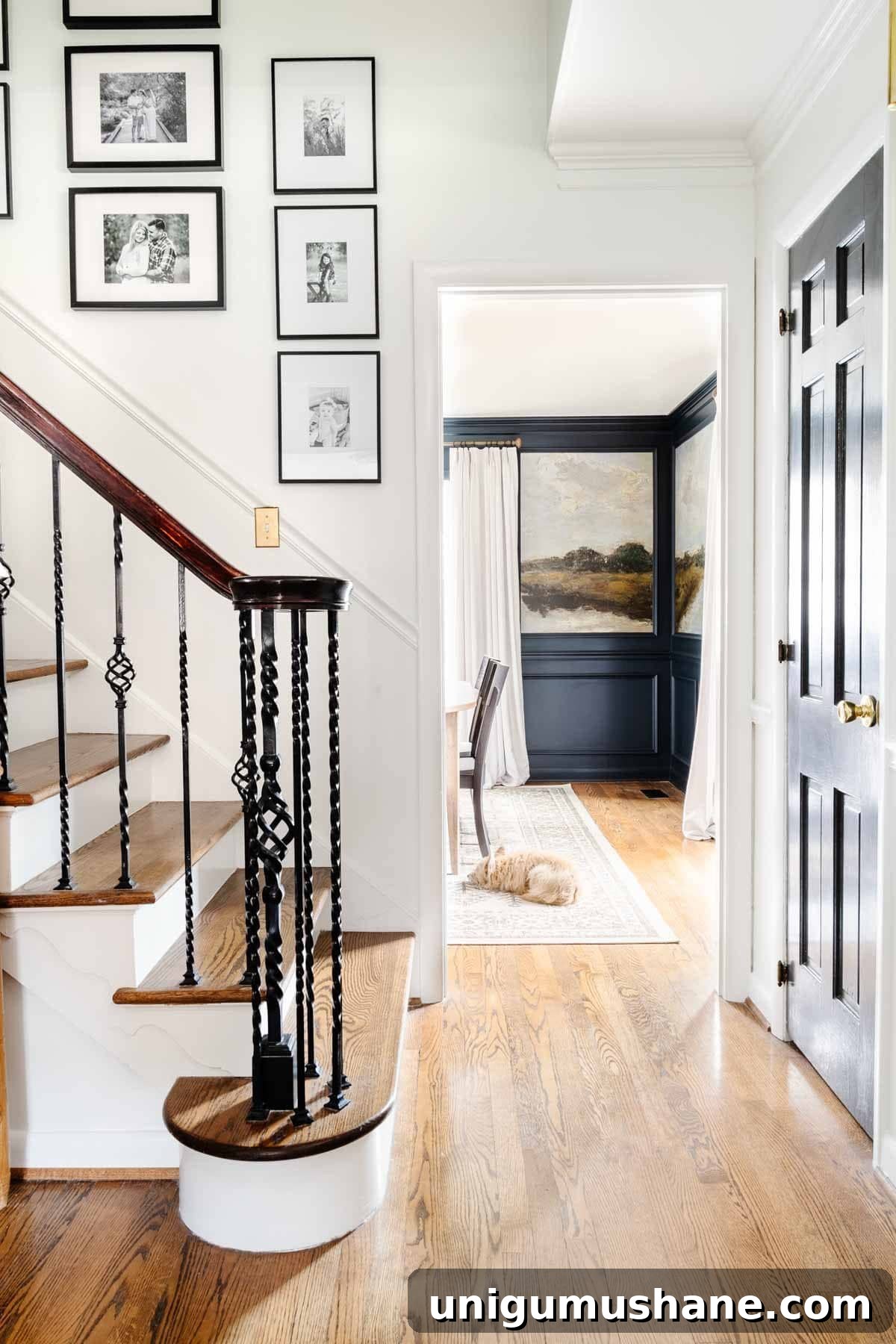 stairway gallery wall with view leading into dining room with mural wallpaper