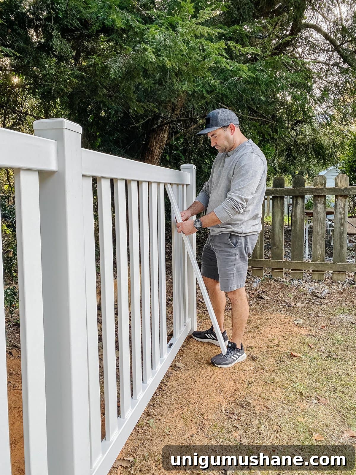 Vinyl Fence Installation: Costs, Materials, and Tips 22 white vinyl fence installation using Ply Gem in a backyard
