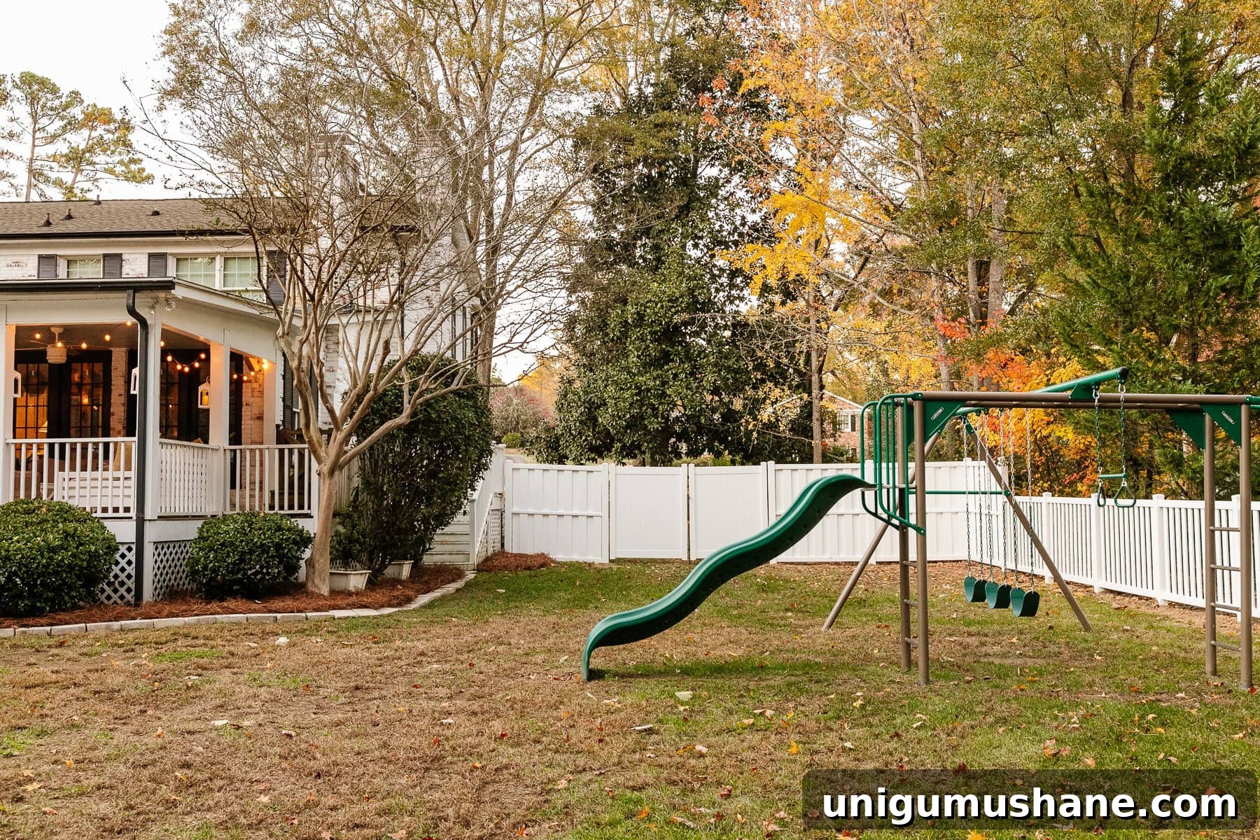 Vinyl Fence Installation: Costs, Materials, and Tips 6 backyard with back porch, playground, and white vinyl fence
