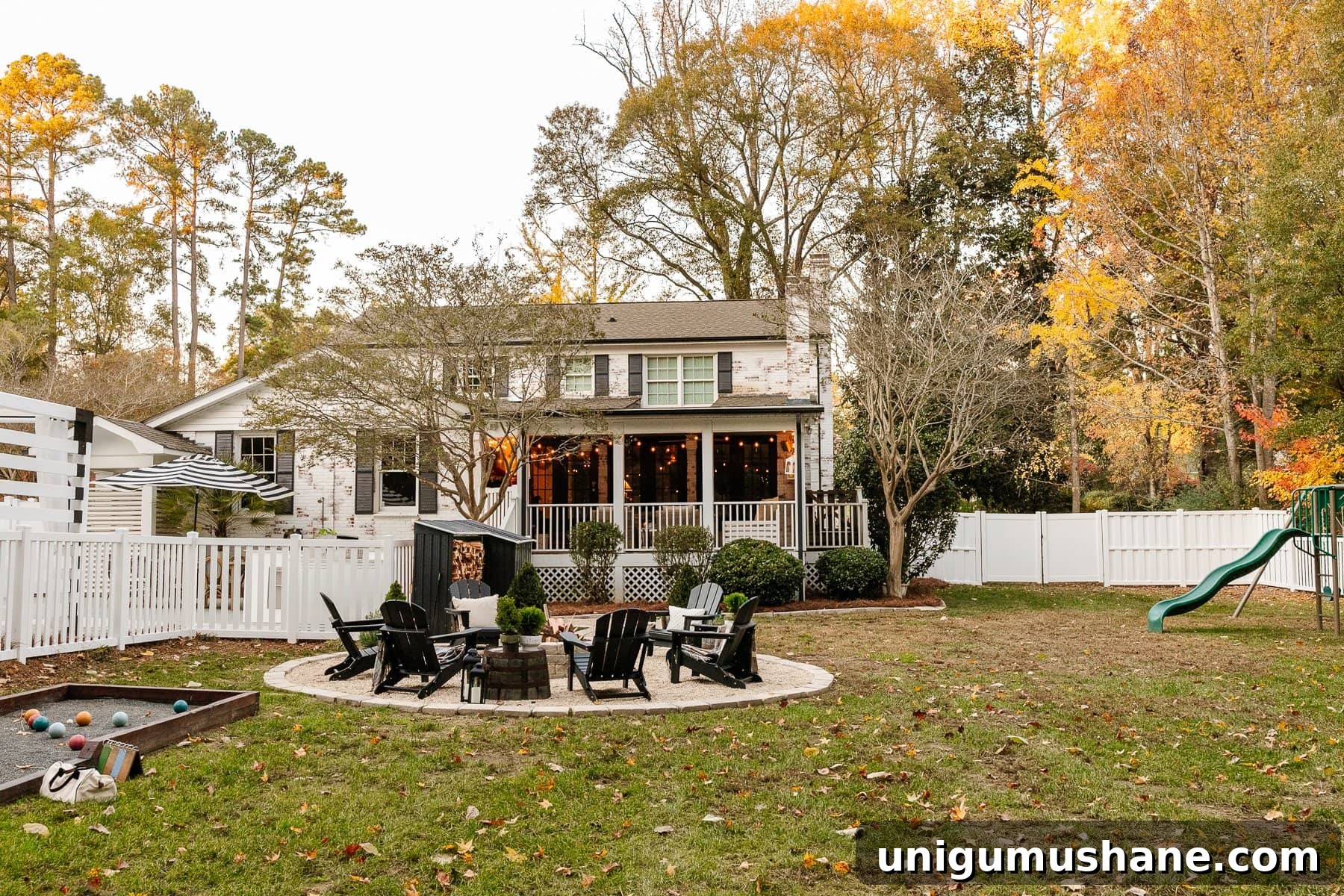 Backyard Renovation Costs: How Much to Expect 7 backyard remodel with fire pit, limewashed brick, playground, bocce ball court, and vinyl fence