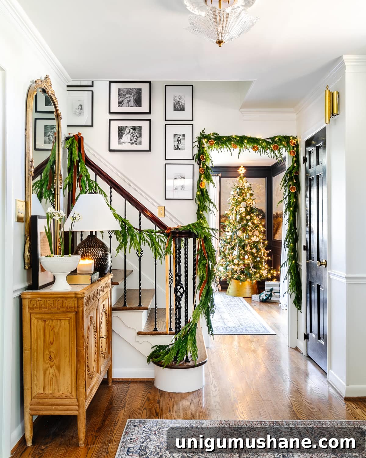 Holiday Housewalk 2021: Traditional Christmas Decorating Ideas 2 Classic Christmas decor ideas in a foyer with realistic garland on stairs and doorway