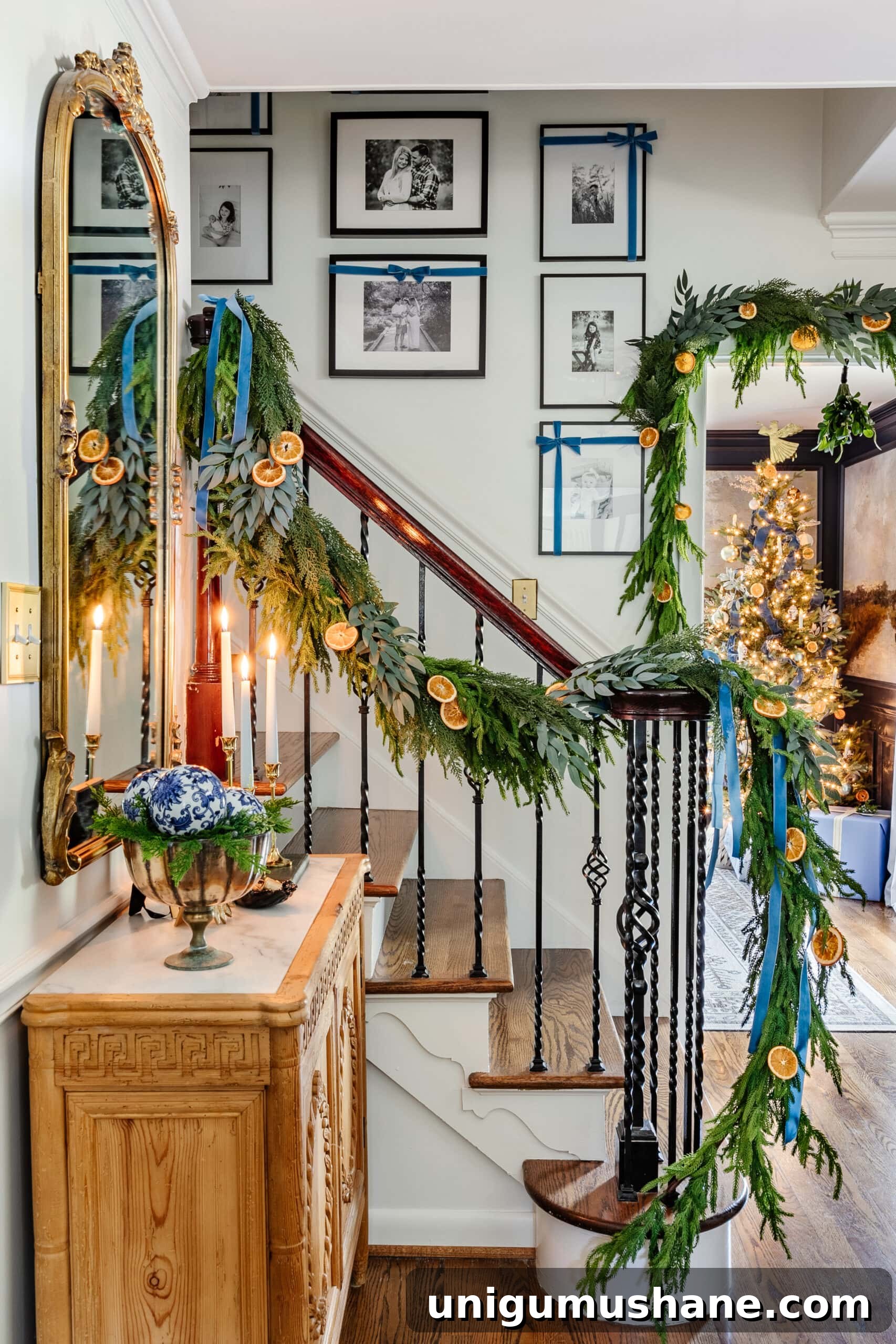 dried orange slices mixed in garland greenery on stairs