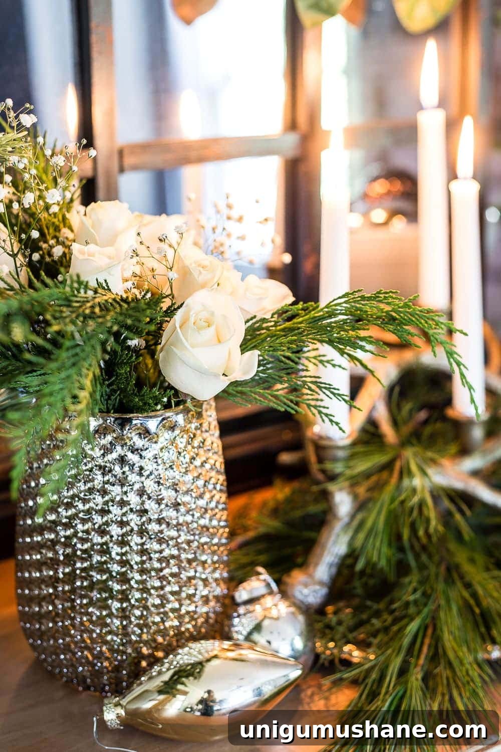 mercury glass vase of pine and roses