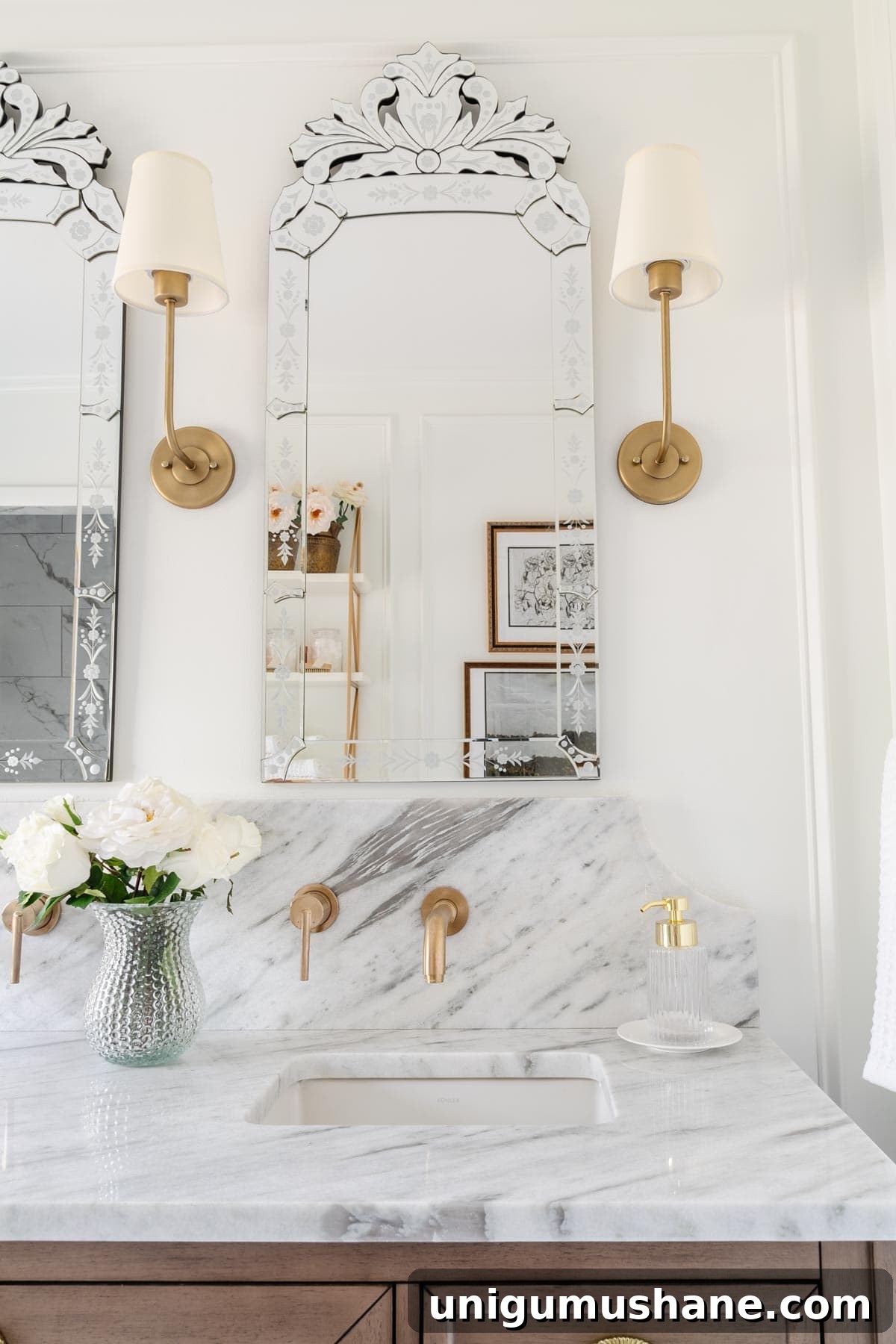 How Much Does a Bathroom Remodel Cost? Budget Breakdown 12 scalloped marble backsplash with wall mounted gold faucets and venetian mirrors