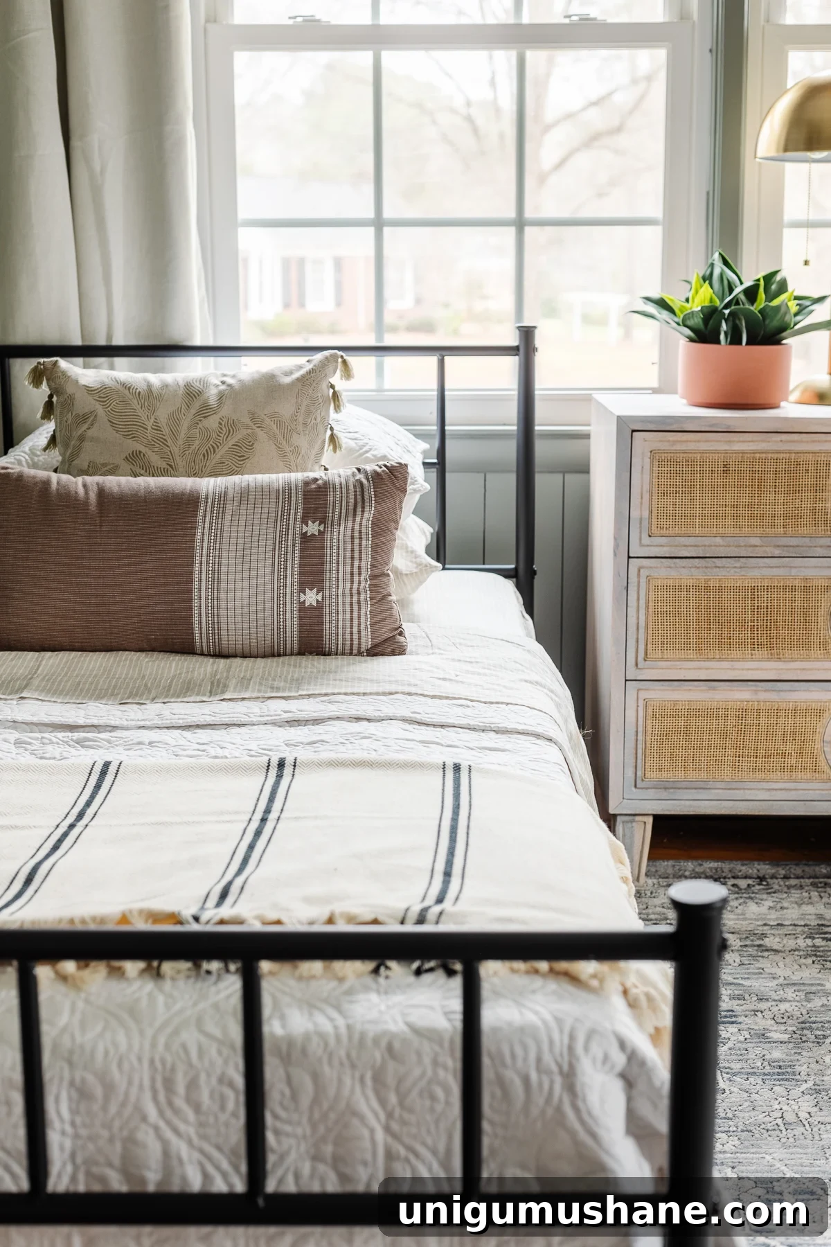 Shared Teen Girls Bedroom with Modern Cottage Style 7 twin bed and rattan nightstand chest in front of a window