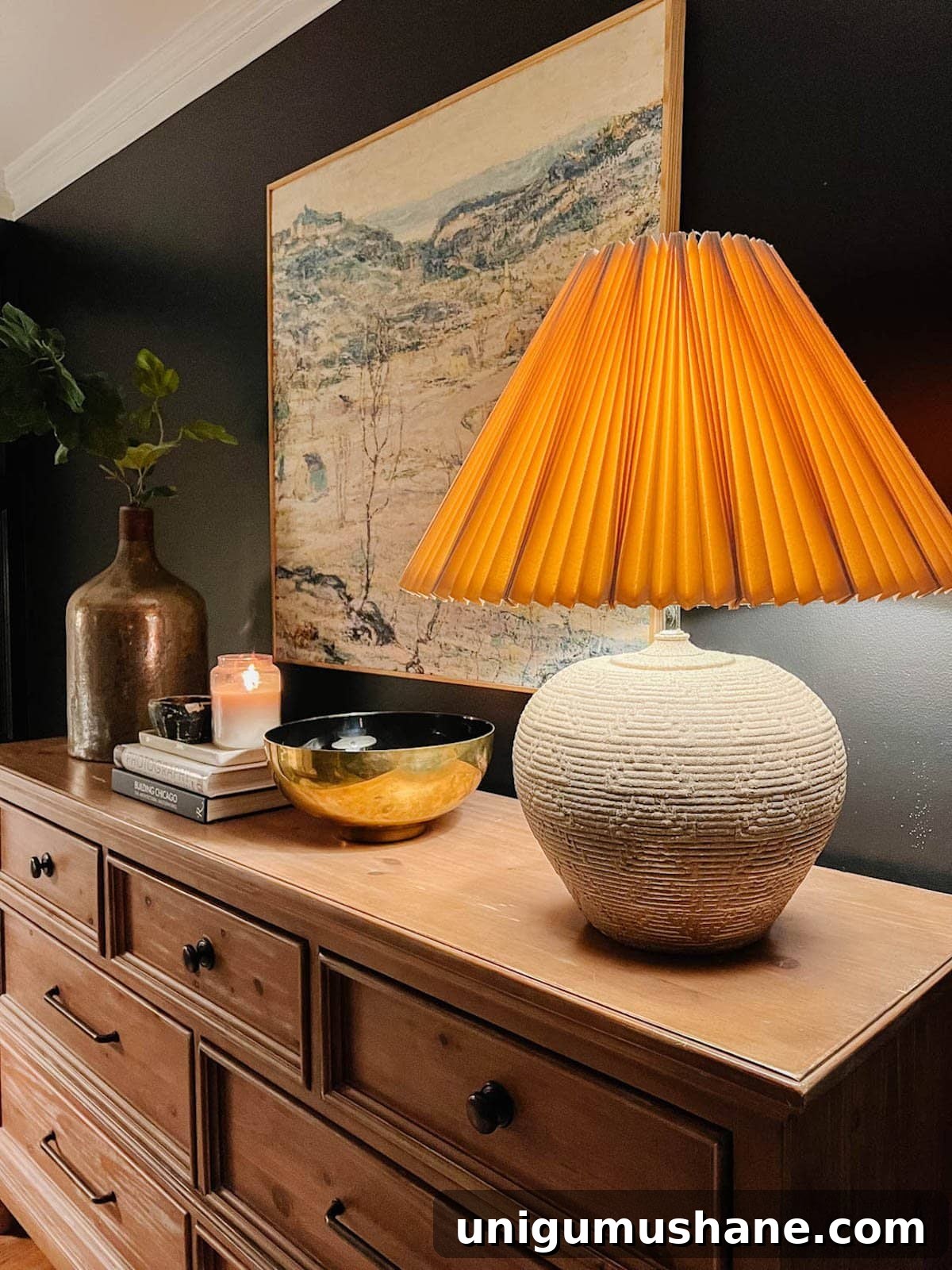 Transform Rustic Table Lamps into Affordable Designer Dupes 4 concrete textured rustic table lamp with pleated lamp shade on bedroom dresser with black walls