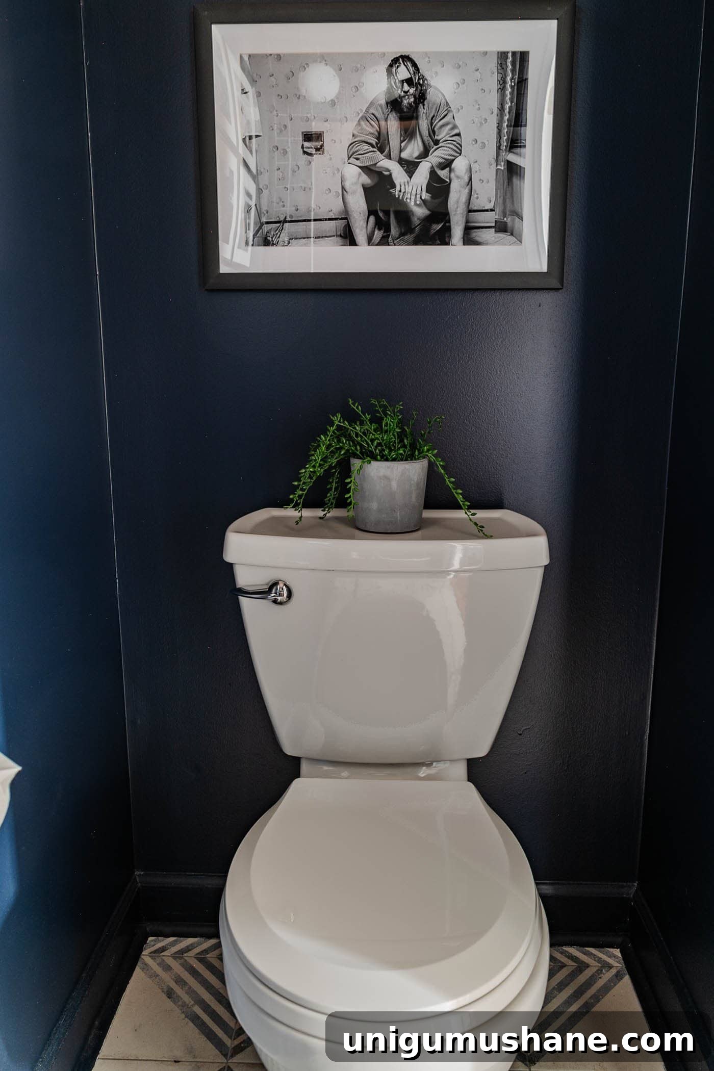 Small Modern Powder Room Makeover for Your Bachelor Pad 11 navy blue small powder room with The Big Lebowski art above toilet
