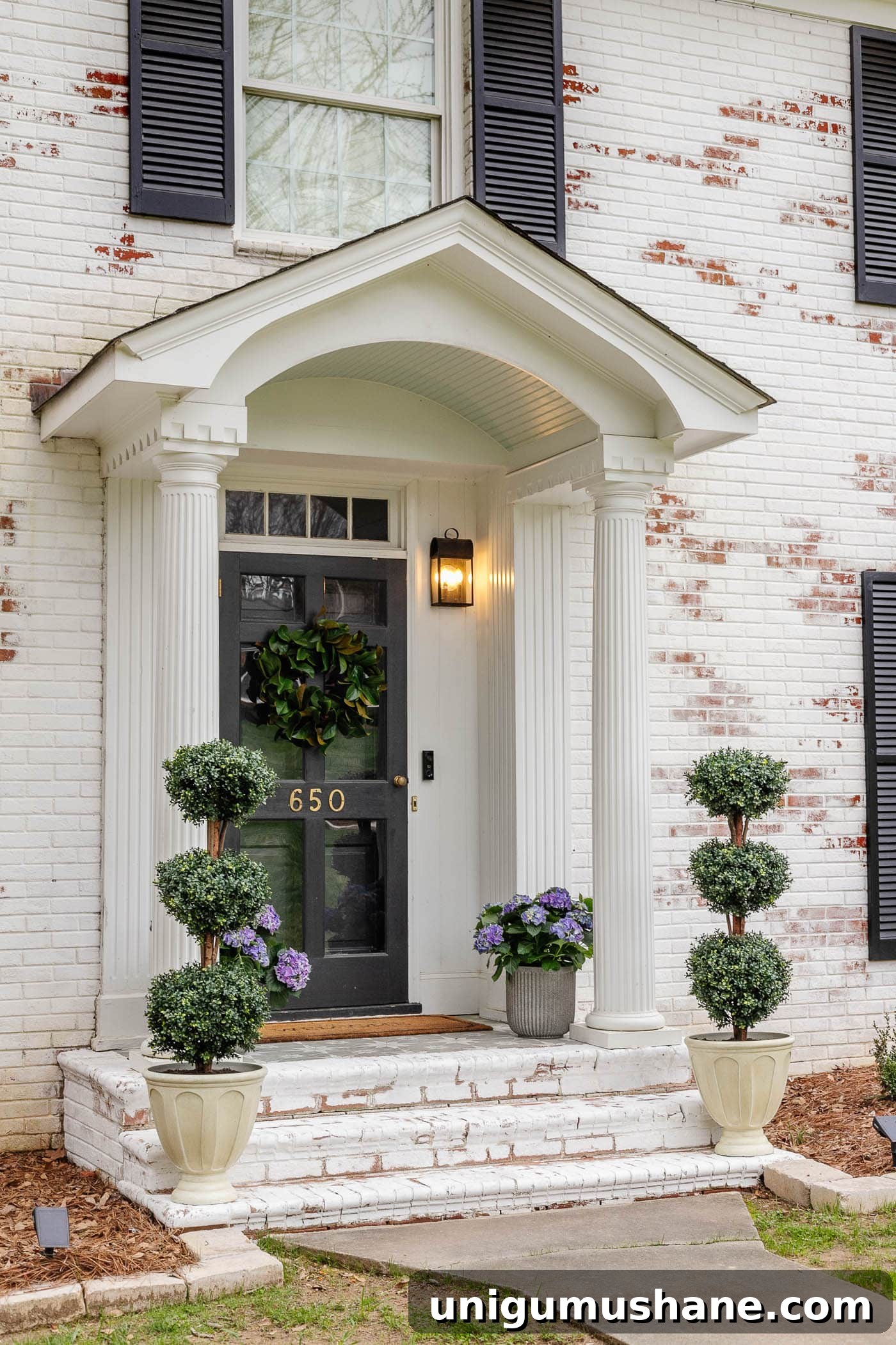 6 Budget-Friendly Small Front Porch Ideas to Boost Curb Appeal 10 limewash brick steps on a colonial house with small porch decor using symmetrical planters