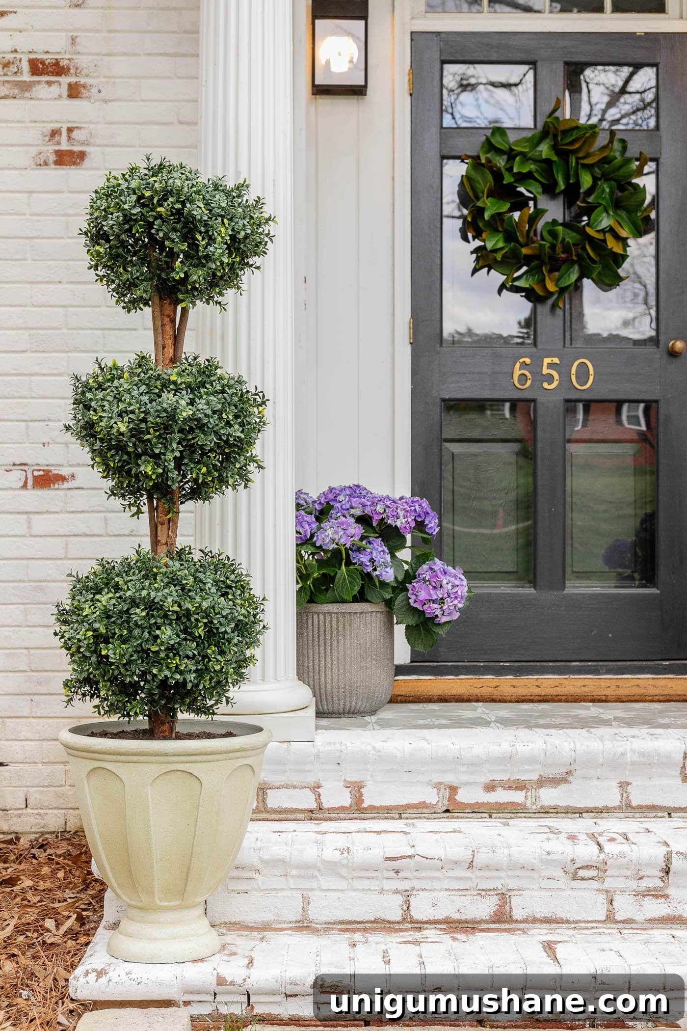 6 Budget-Friendly Small Front Porch Ideas to Boost Curb Appeal 7 boxwood topiary in an urn planter and fluted concrete planter with purple hydrangeas on a small front porch stoop