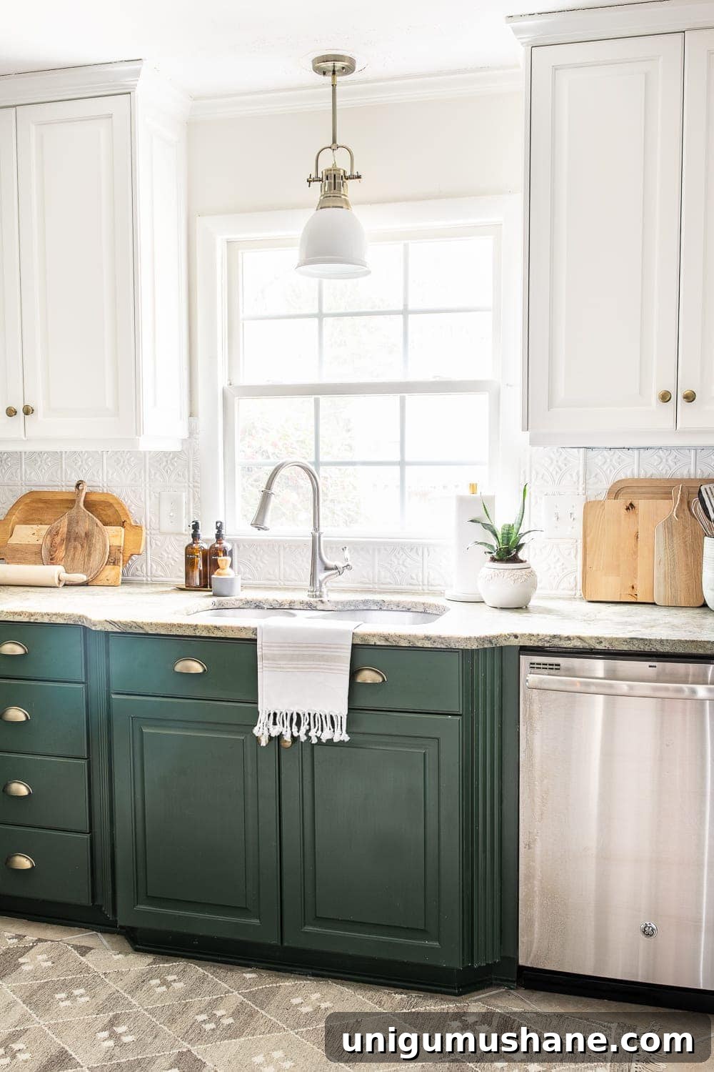 white pressed tin backsplash in a kitchen with white and green cabinets
