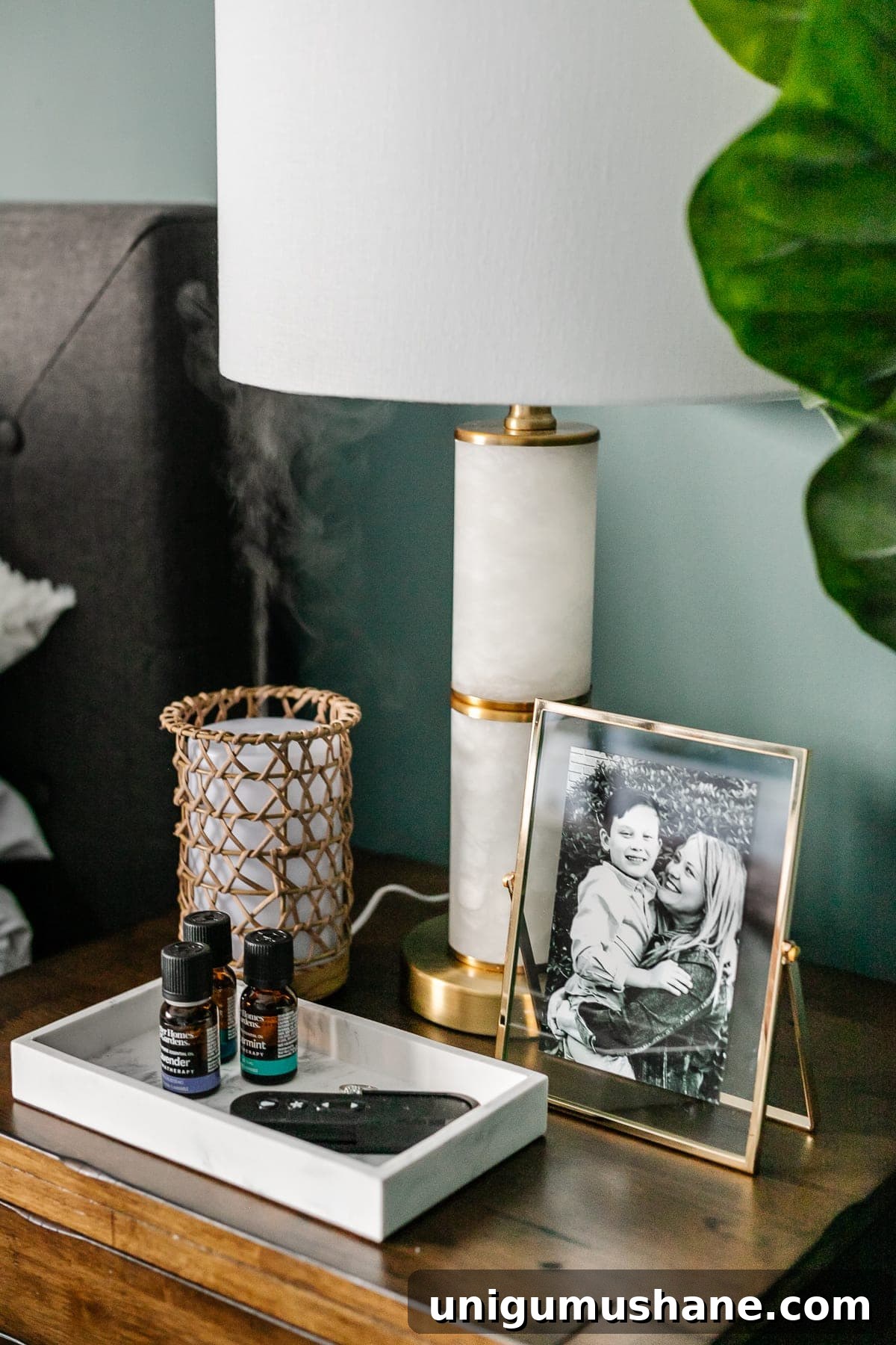 how to make your house look expensive - be mindful of your home's scent - diffuser on a nightstand with nightstand decor