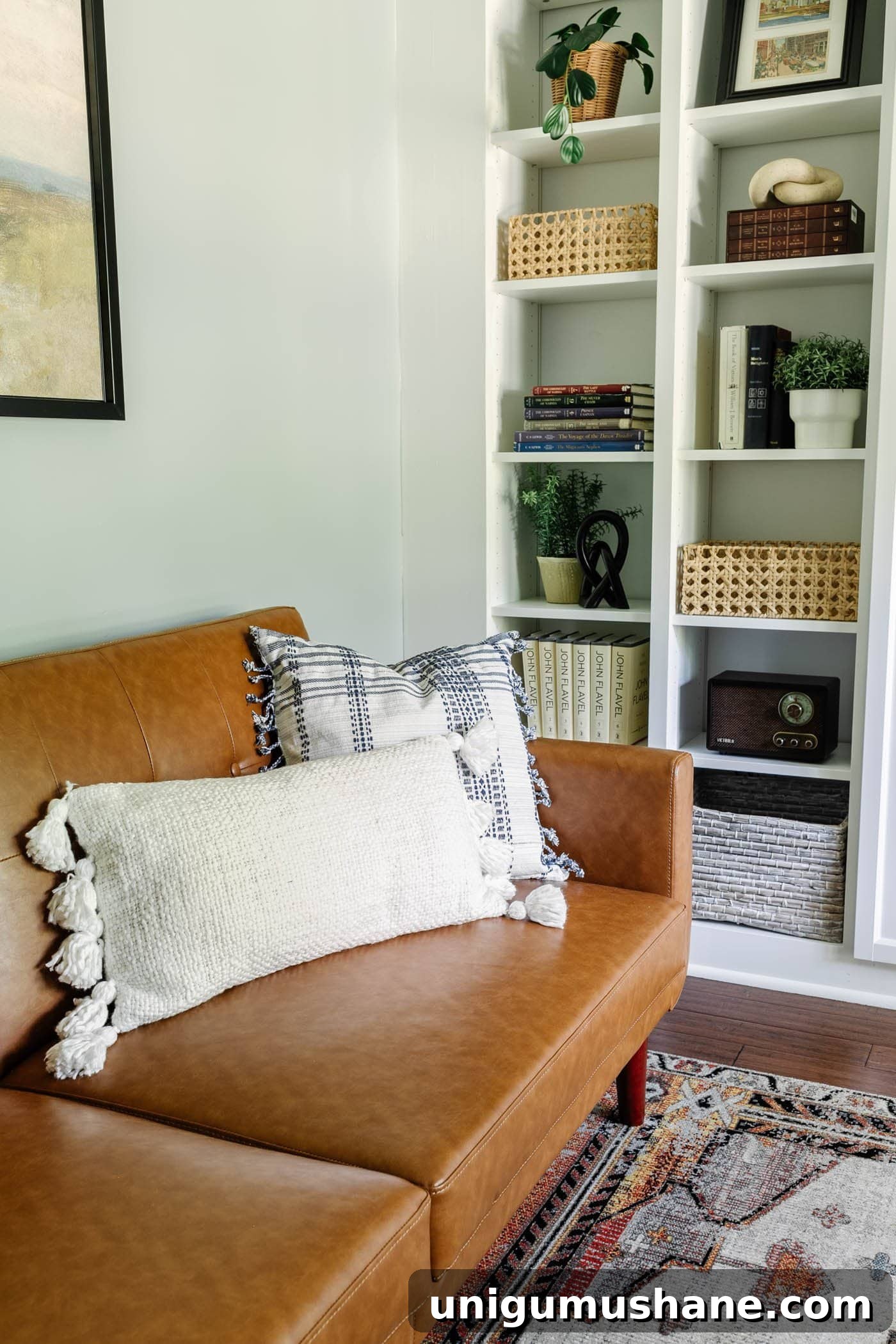 8 Lounge-Style Home Office Ideas to Boost Productivity 7 office lounge throw pillows and shelf decor with plants, baskets, and books