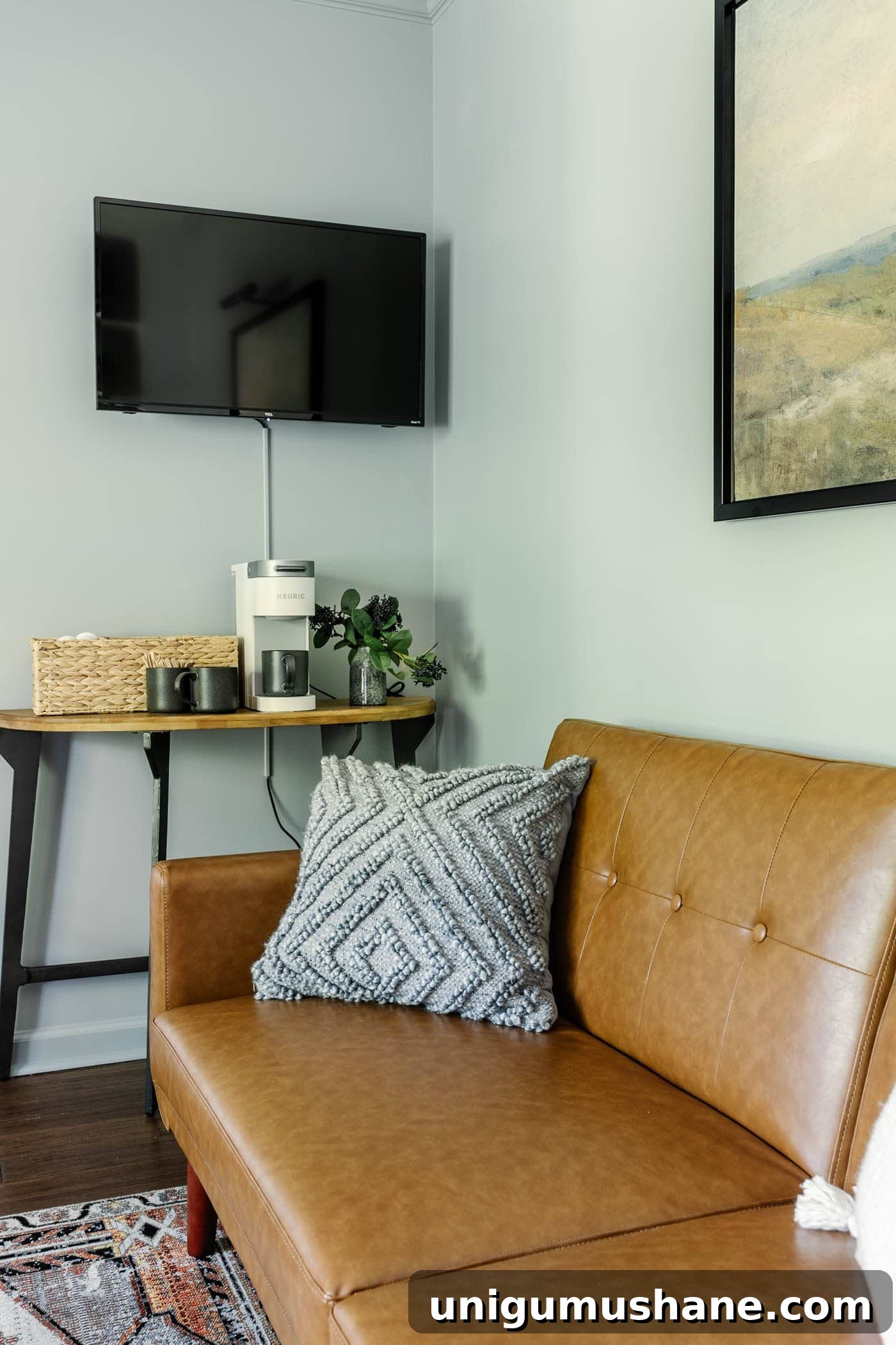 home office coffee bar table and wall mounted TV with a futon for guests