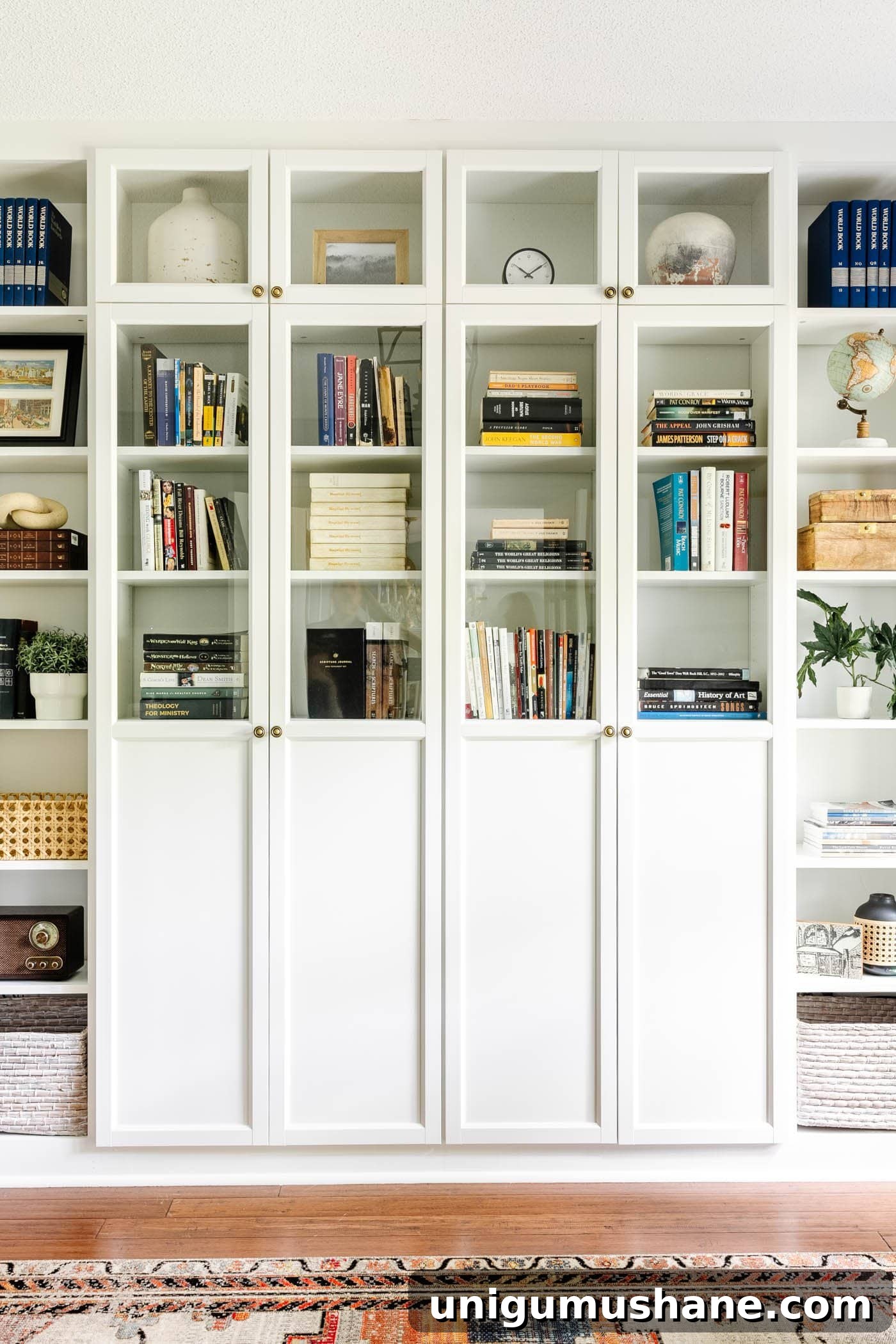 white IKEA built-in shelves with oxberg doors for book storage