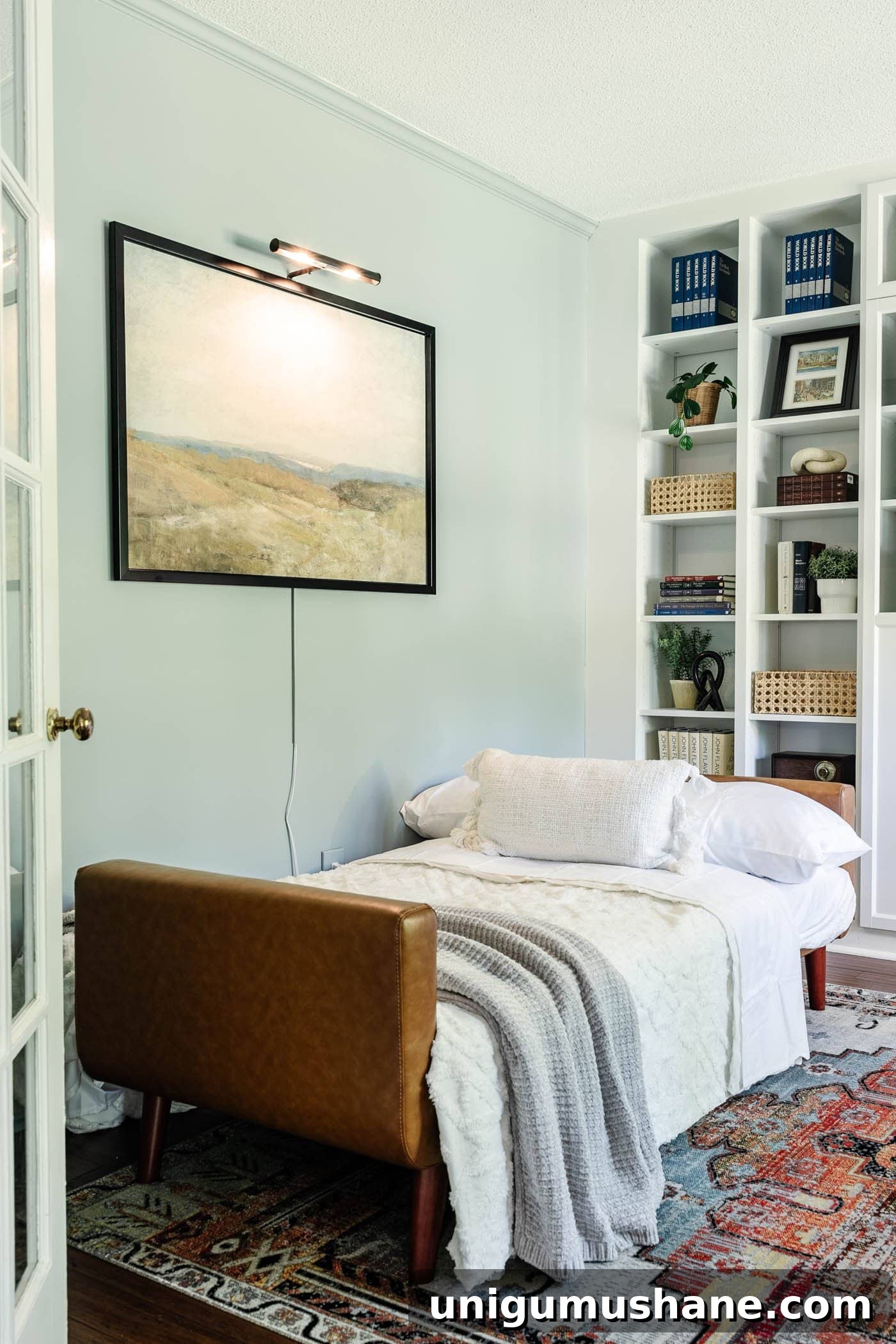 faux leather futon folded out into a bed in a home office