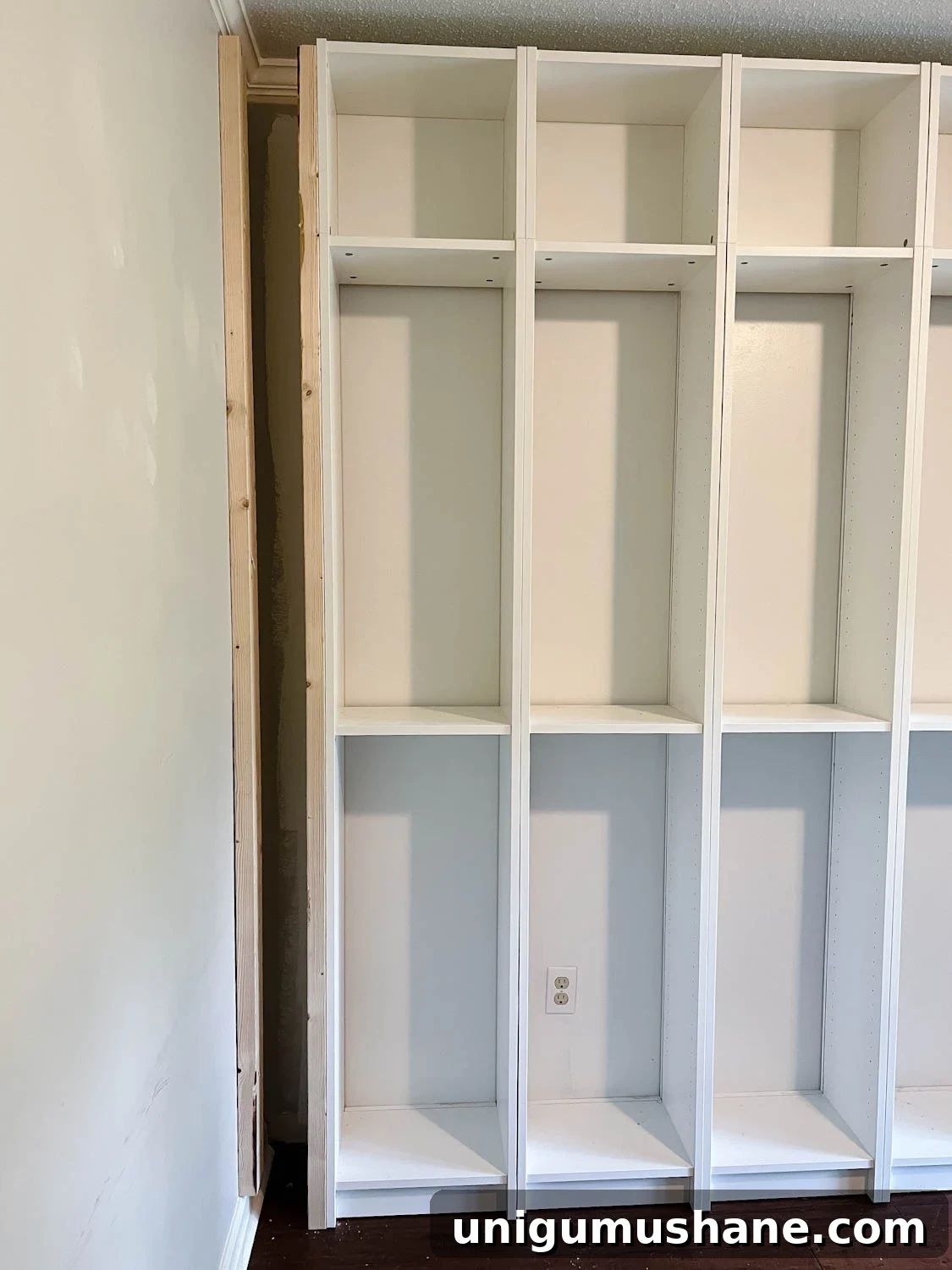 Convert IKEA Billy Bookcases into Built-In Bookshelves 13 using 2x4 boards to brace sides and fill gaps to make bookcases look built in for the IKEA Billy bookcase hack