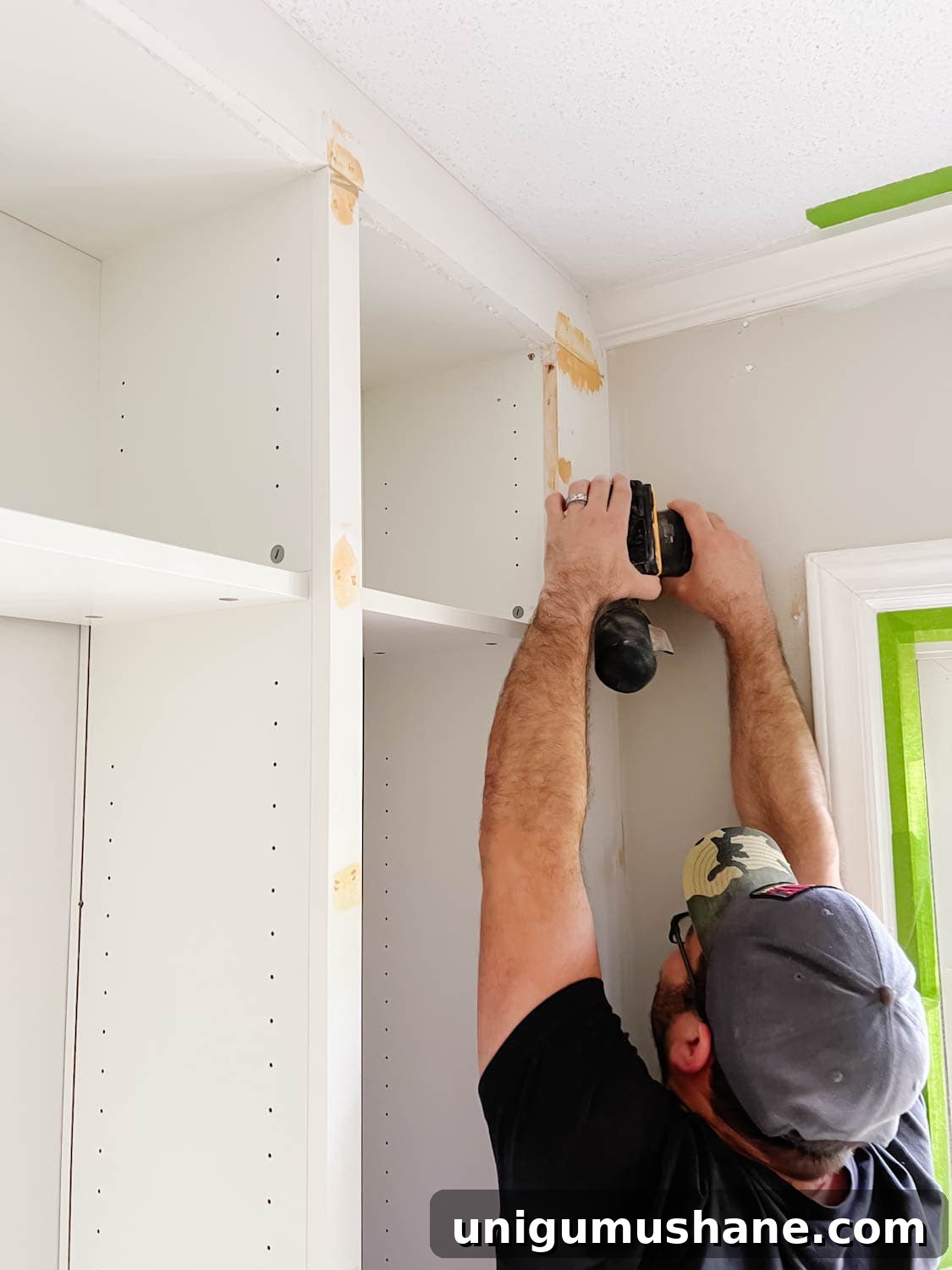 Convert IKEA Billy Bookcases into Built-In Bookshelves 23 orbital sander used to smooth out wood filler and Loctite foam