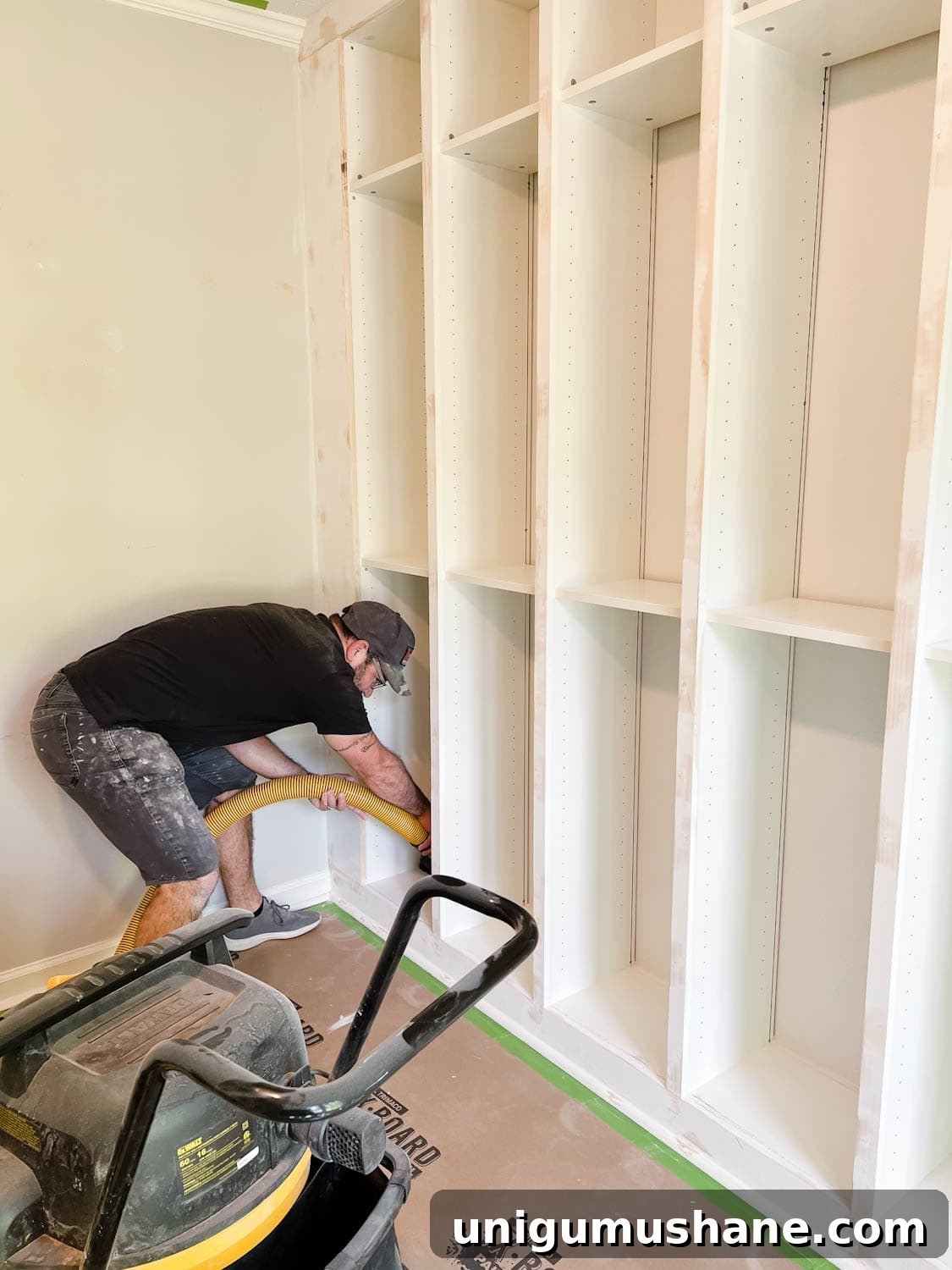 Convert IKEA Billy Bookcases into Built-In Bookshelves 24 using a shop vac to remove sanding dust from shelves