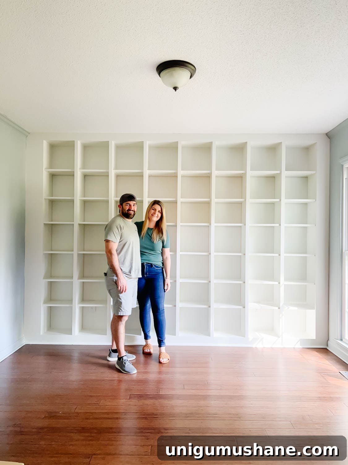 Convert IKEA Billy Bookcases into Built-In Bookshelves 25 newly painted IKEA Billy bookcase shelves to make them look like one solid built in piece