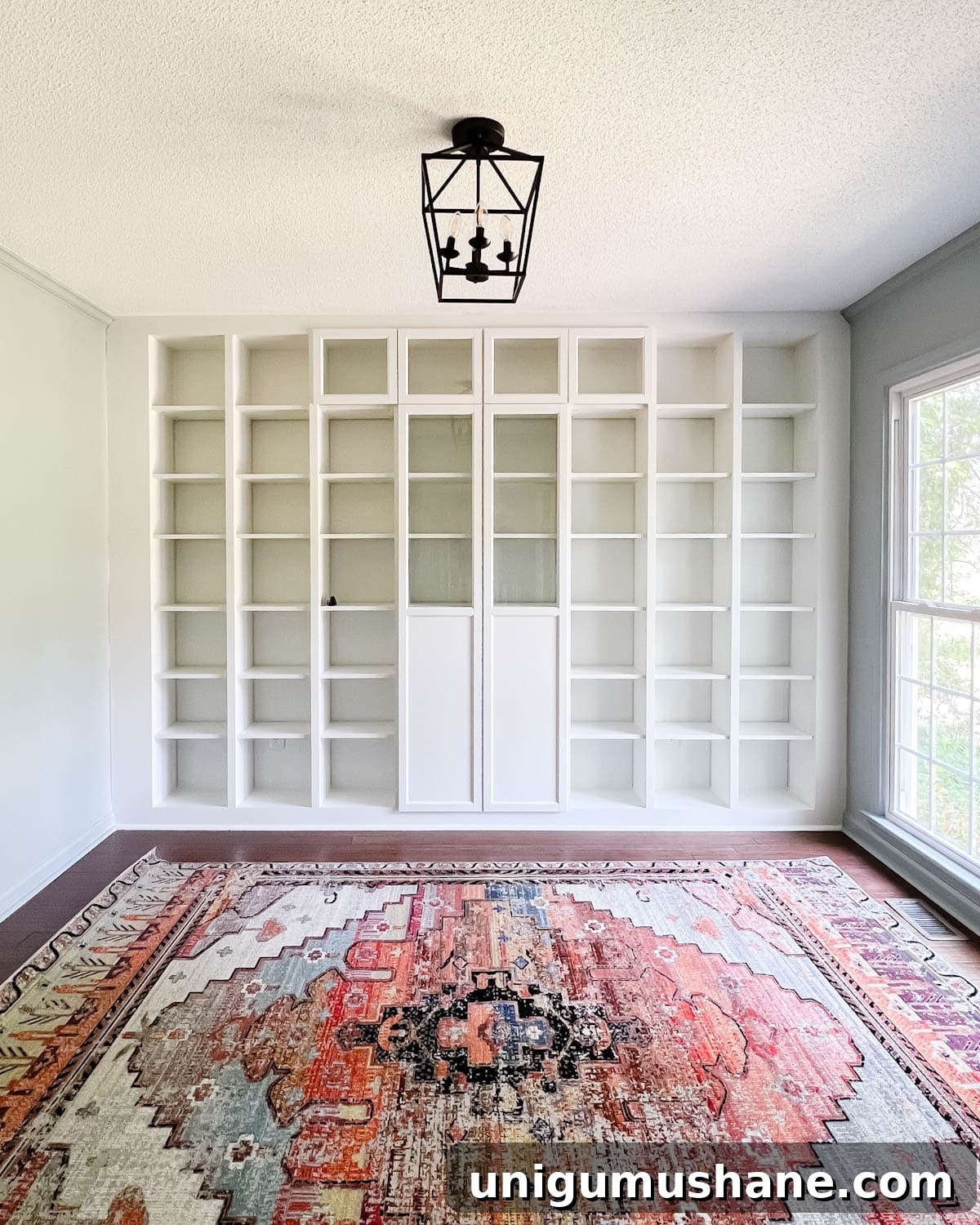 Convert IKEA Billy Bookcases into Built-In Bookshelves 26 Oxberg doors added to bookcases for concealed storage