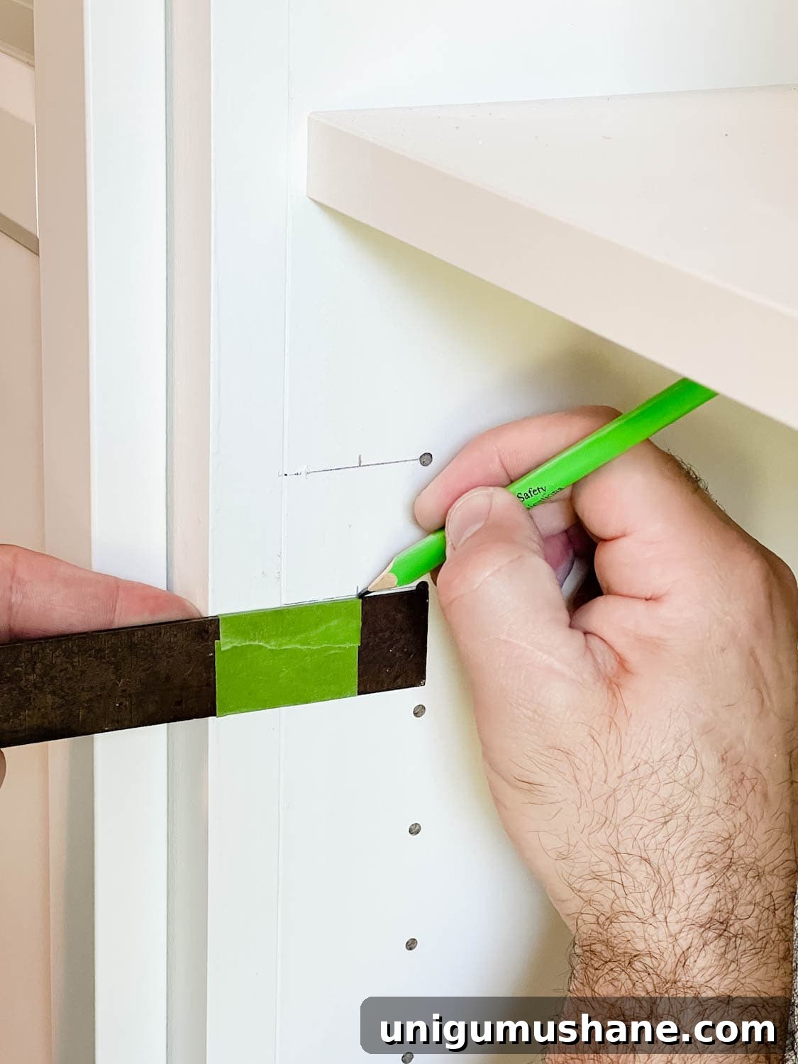 Convert IKEA Billy Bookcases into Built-In Bookshelves 28 using a combination square to mark new holes for door hardware
