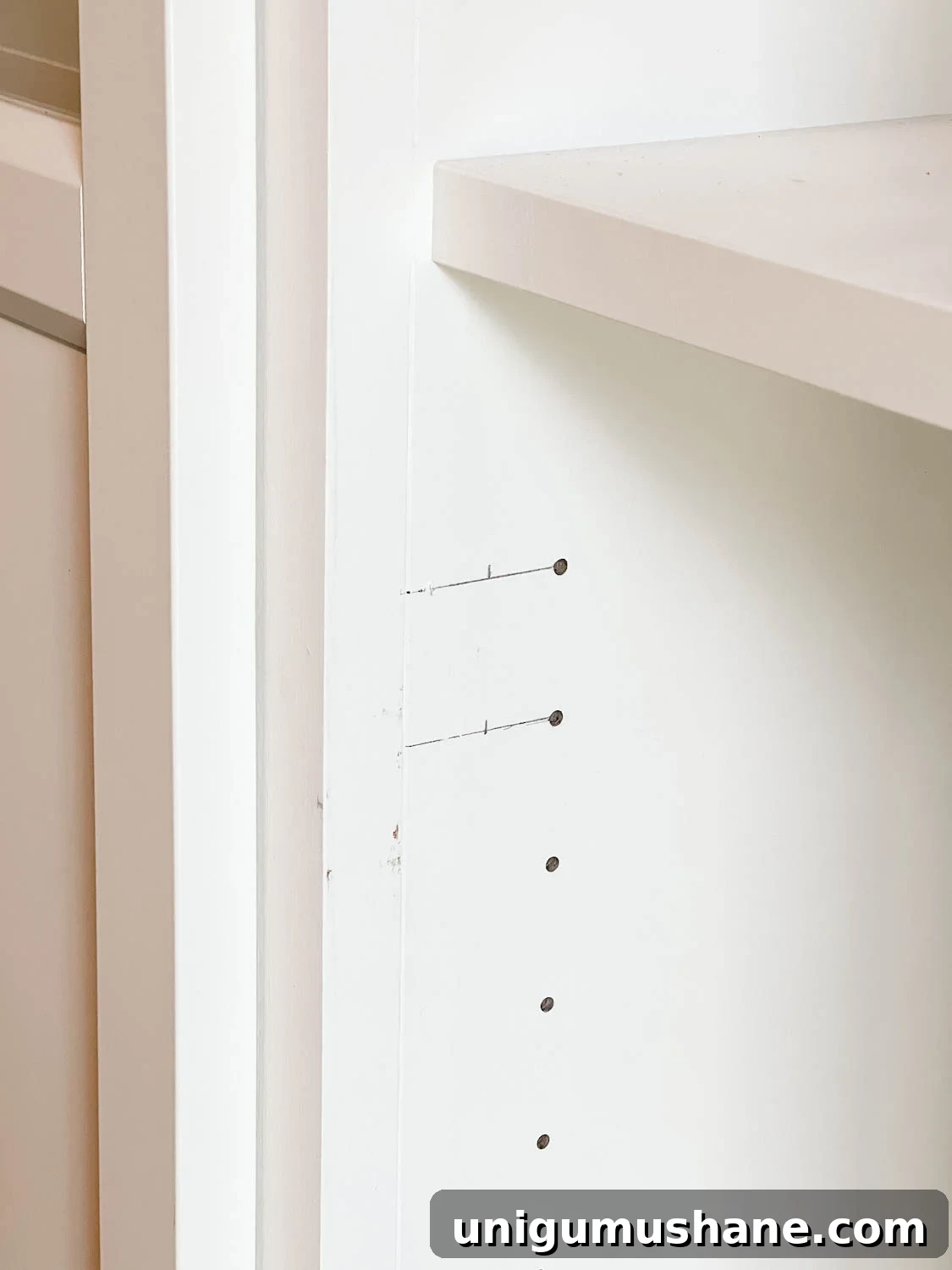 Convert IKEA Billy Bookcases into Built-In Bookshelves 30 new holes marked for drilling to hang shelf doors