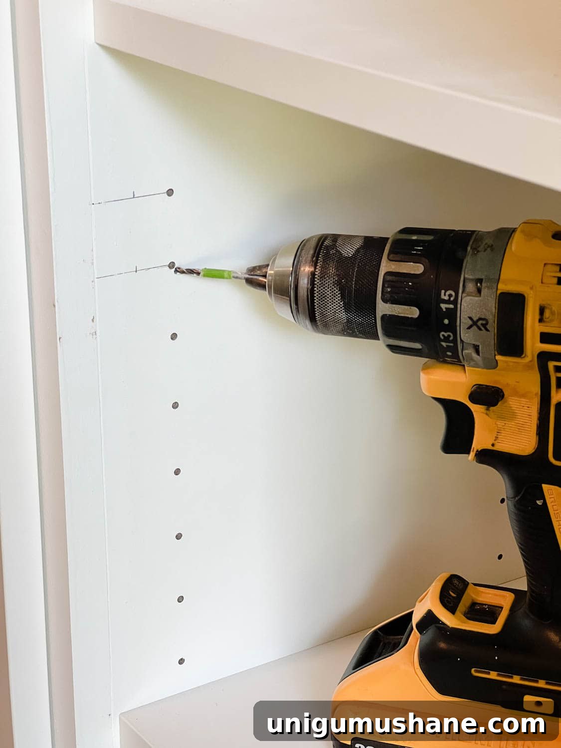 Convert IKEA Billy Bookcases into Built-In Bookshelves 31 using tape on a drill bit to mark hole depth
