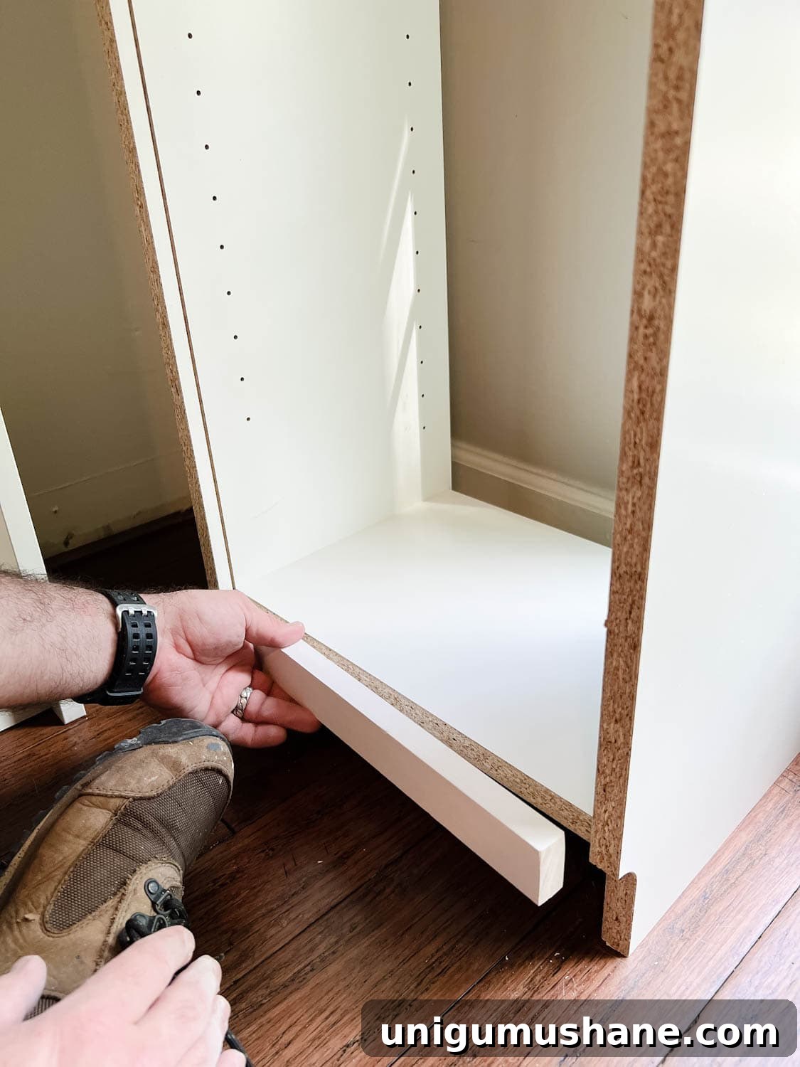 Convert IKEA Billy Bookcases into Built-In Bookshelves 7 adding a 1x2 to the back of a bookcase to fill a gap to make diy built in bookshelves