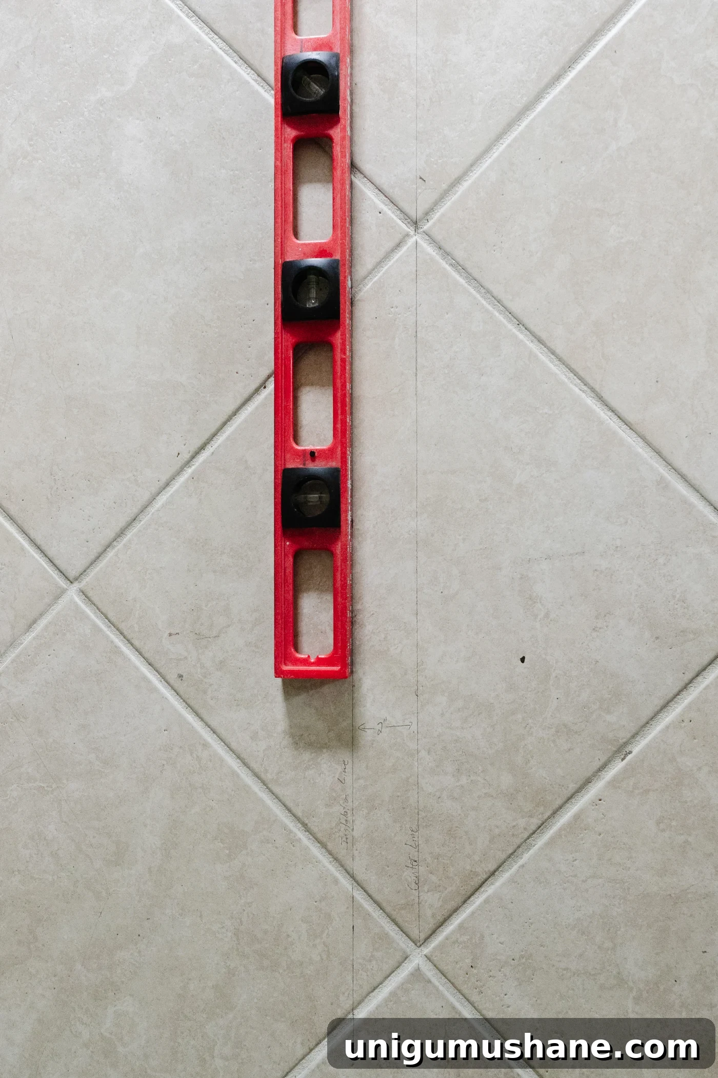 using a level to draw a starting line to lay flooring