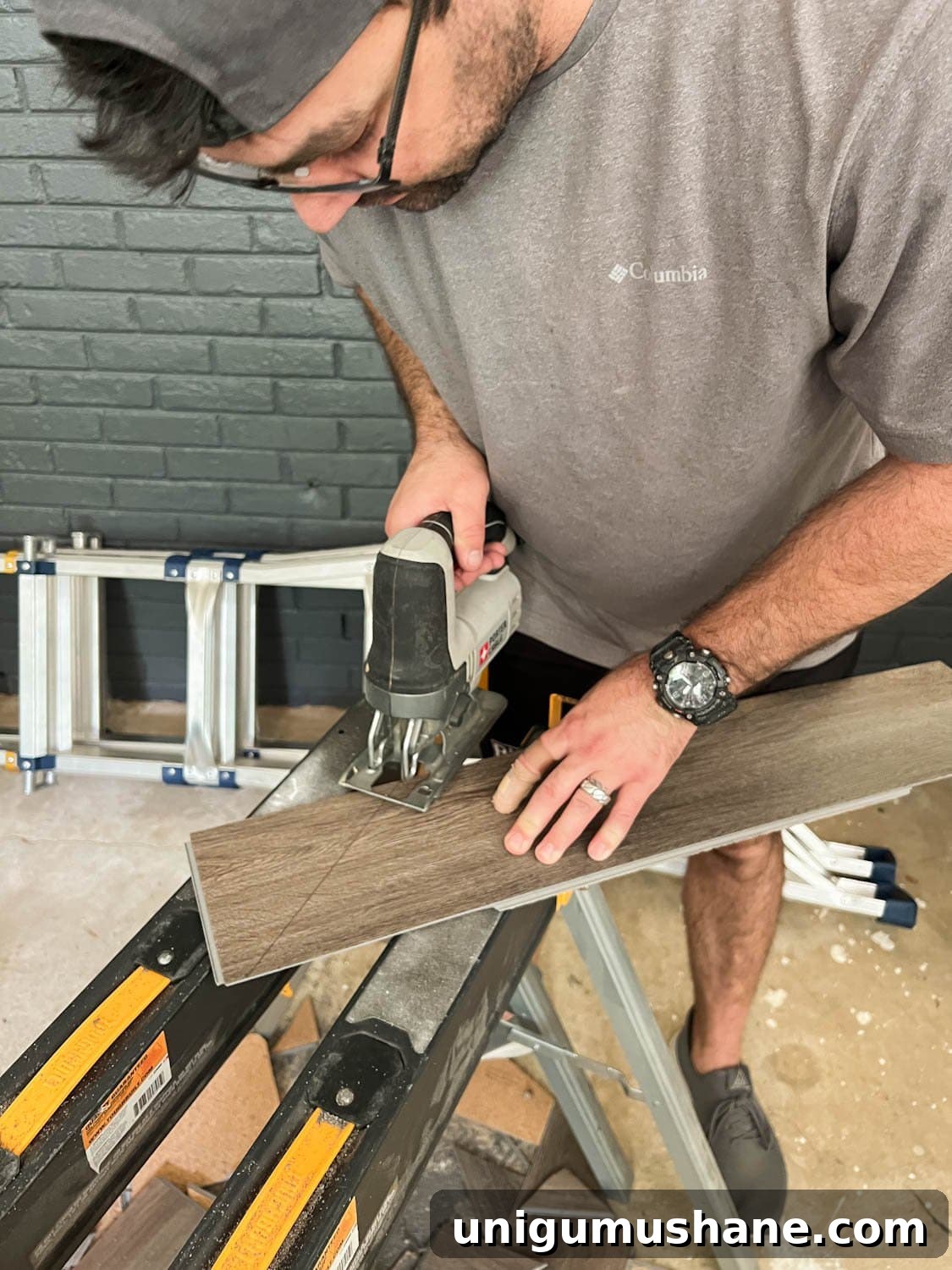 cutting a piece of LVP floor with a jigsaw