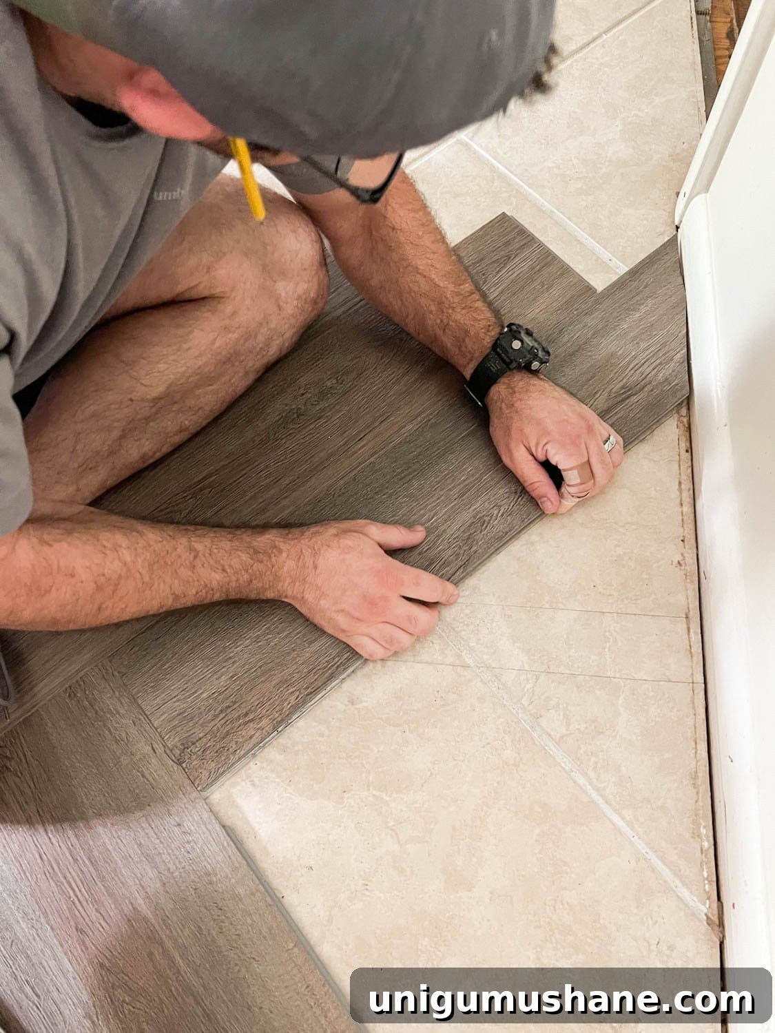 fitting herringbone vinyl flooring against a wall's edge