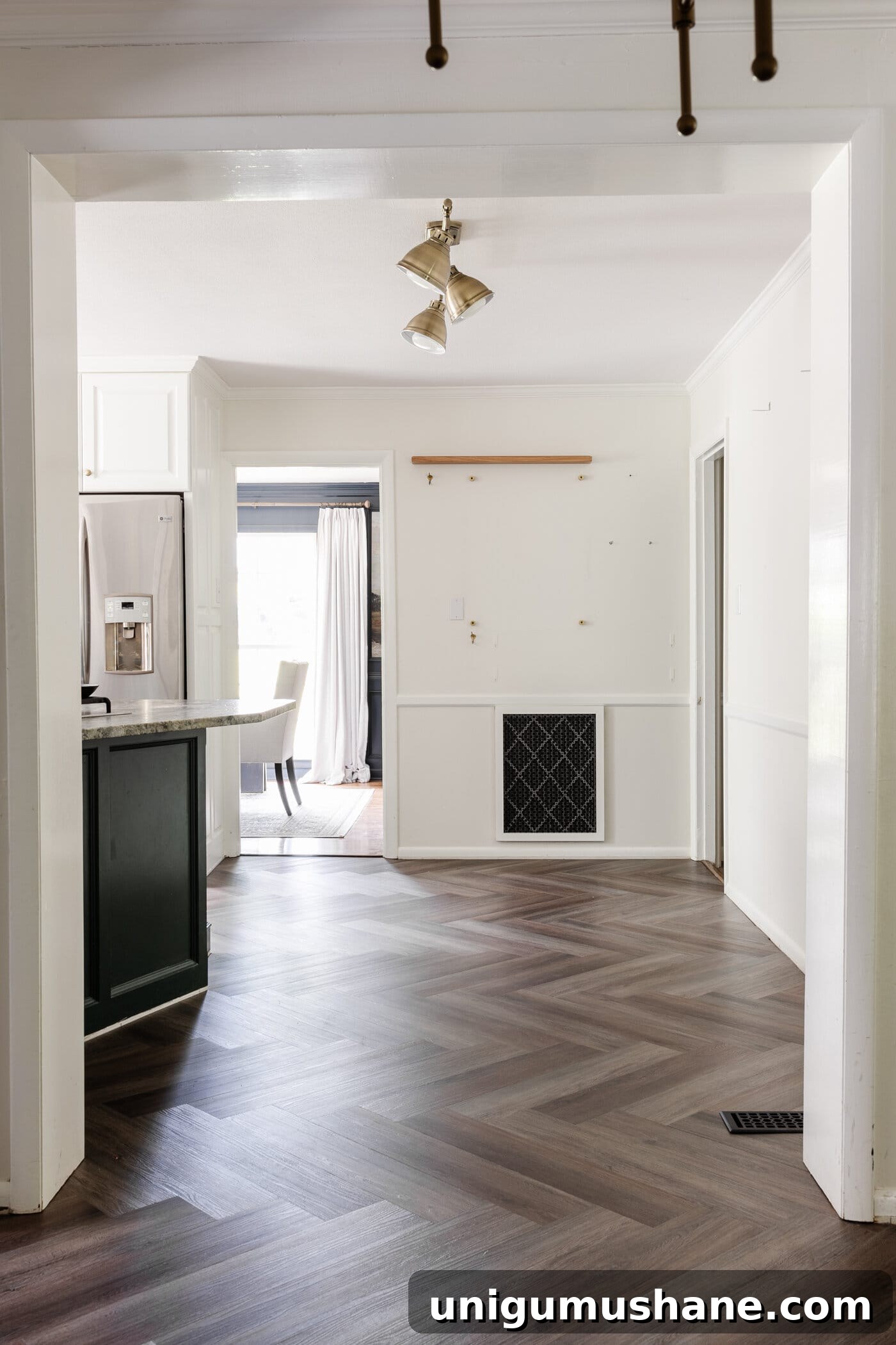 finished ProCore Floor herringbone LVP floating floor over tile in a kitchen