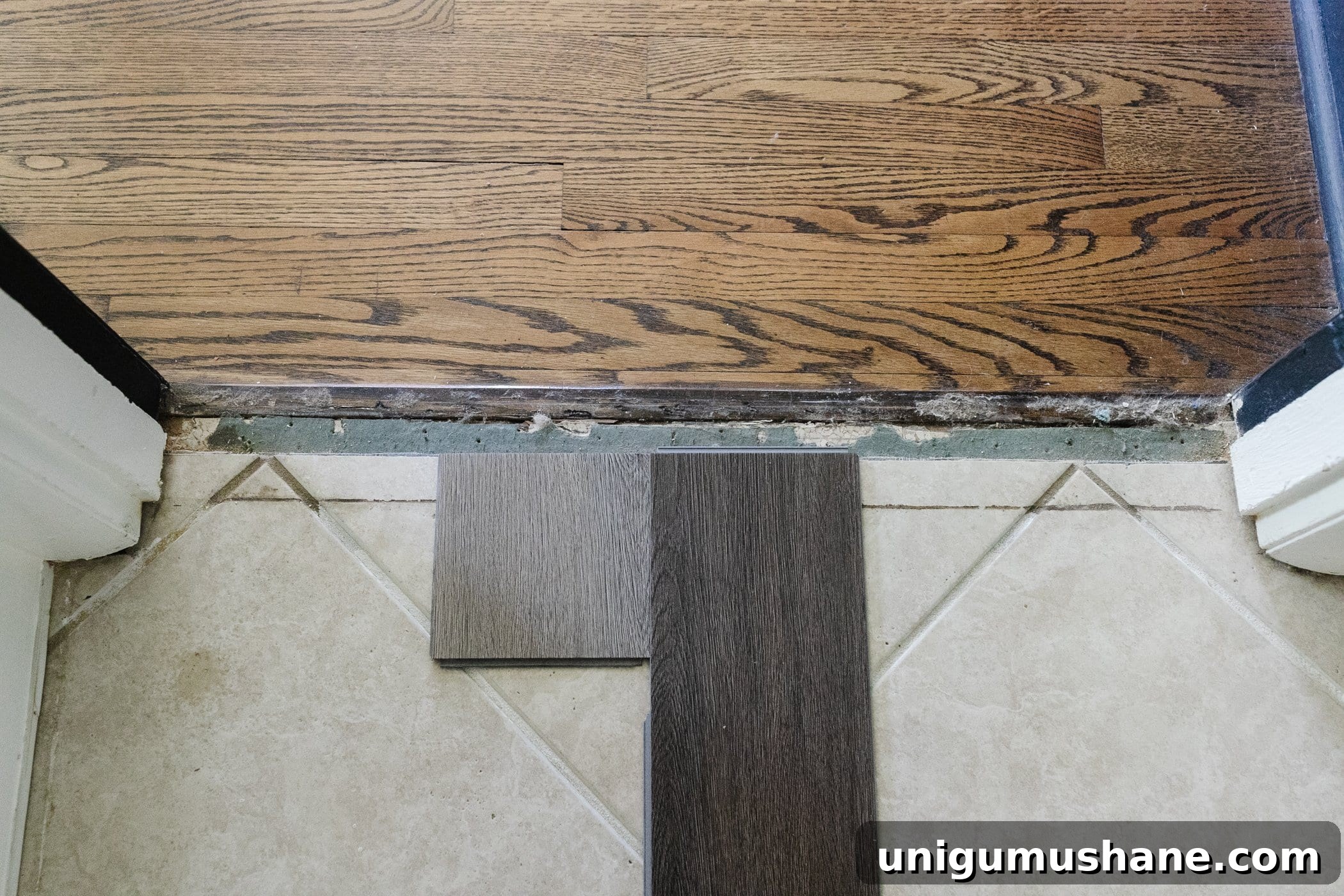 Light beige and dark brown herringbone LVP floor samples on top of beige tile 