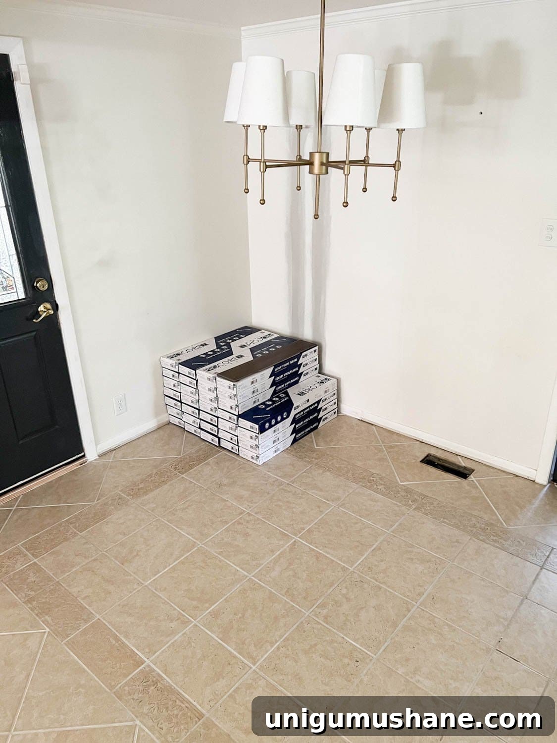 stack of LVP flooring on top of tile floor